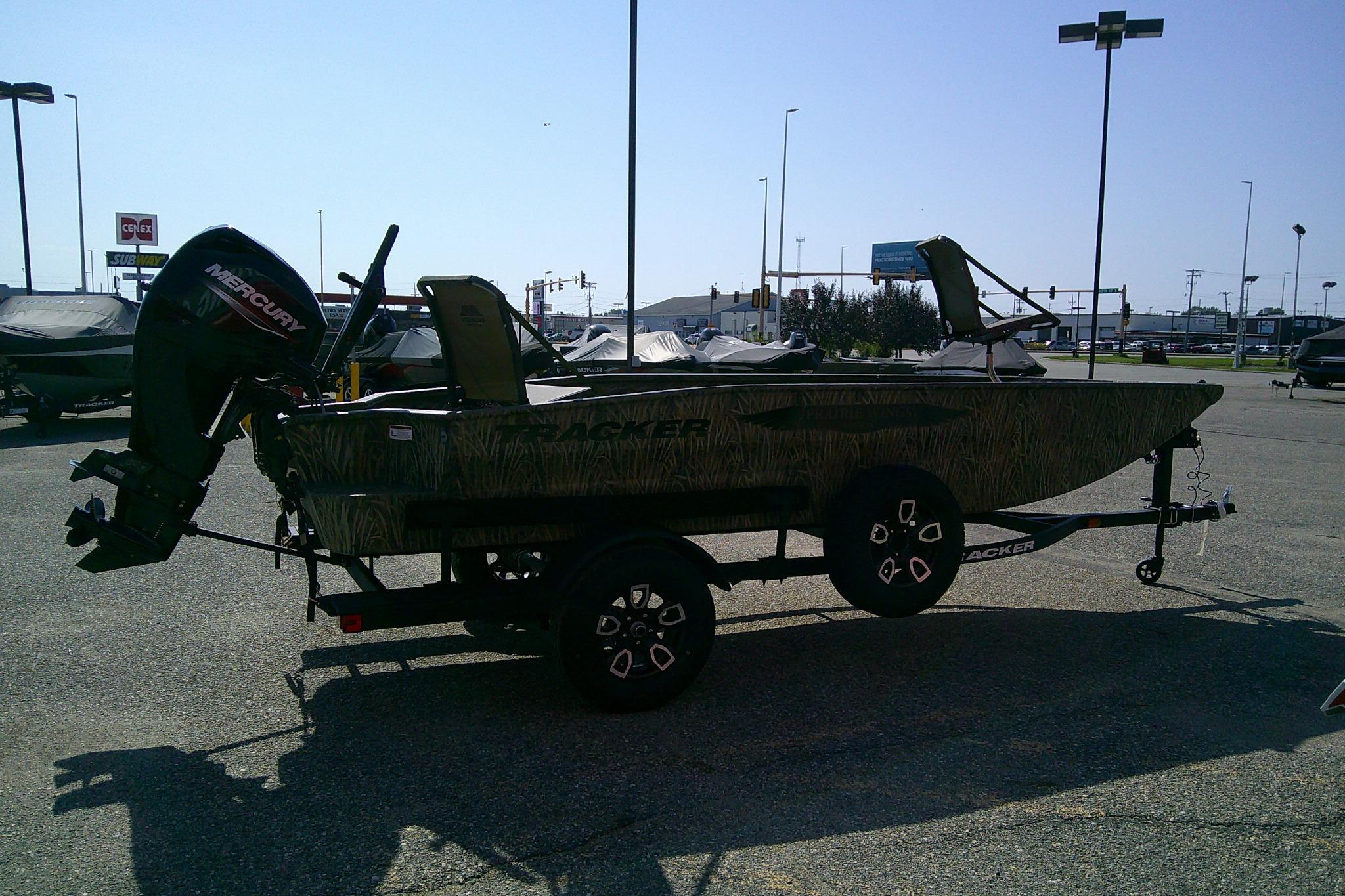 2026 Tracker Grizzly 1650 T Prairie Wings Edition boat on trailer in parking lot.