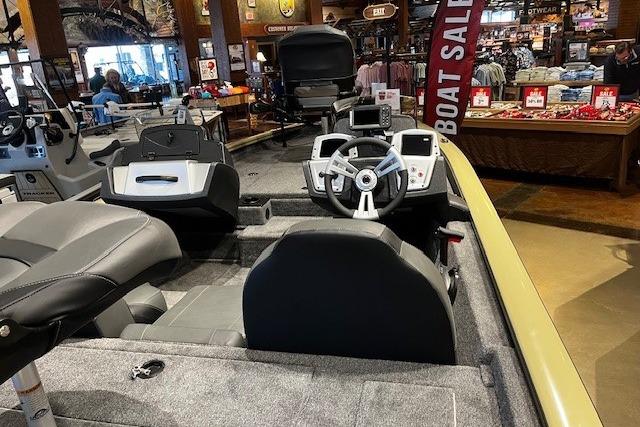 2026 Tracker Pro Team 175 boat interior at showroom, featuring steering wheel and seating.