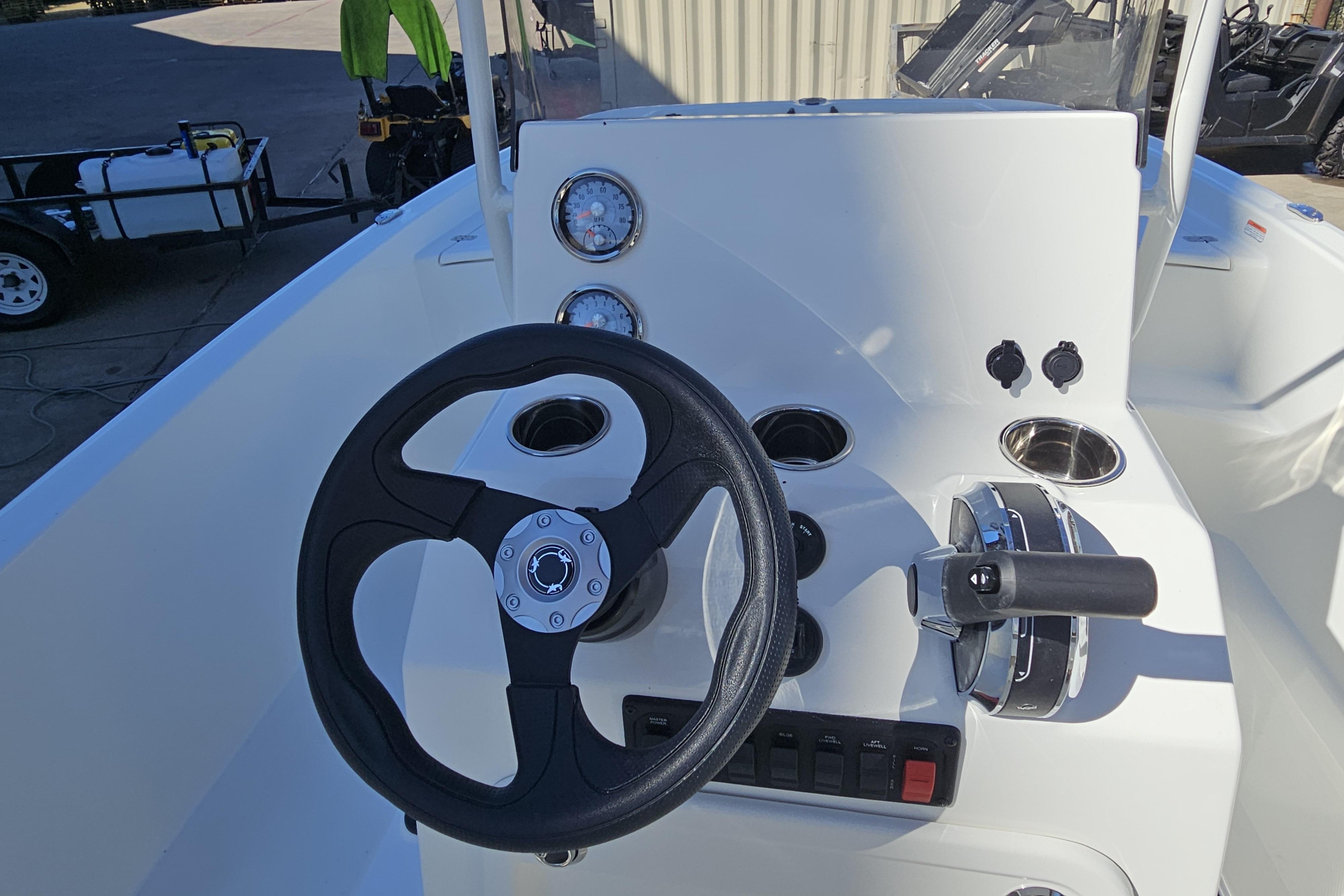 Steering console of 2026 Mako Pro Skiff 19 CC boat with gauges and controls.