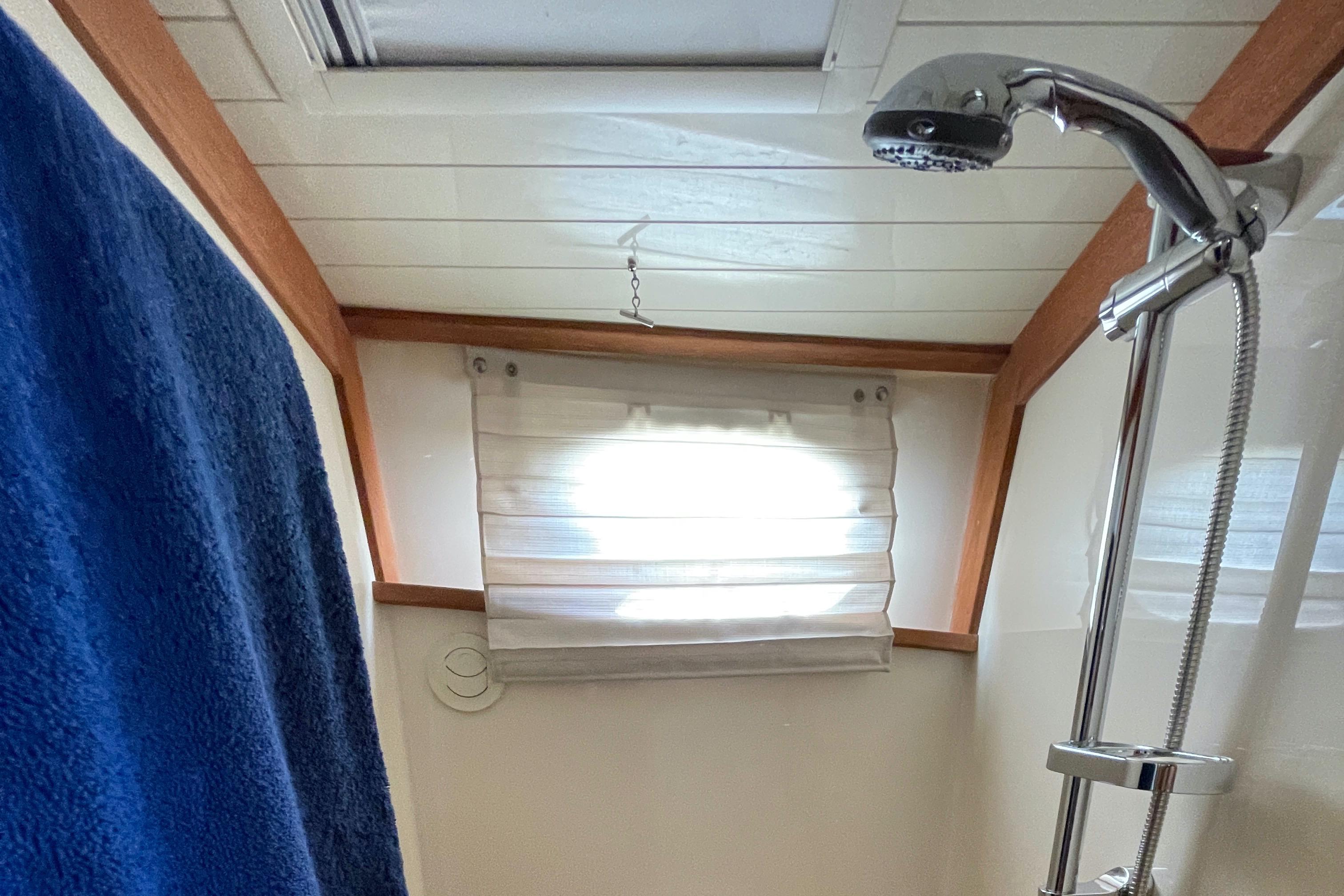 Shower area in 2007 Hinckley Talaria 44 Flybridge with blue towel and window.