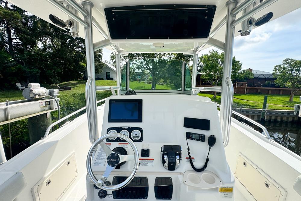 2018 Mako 284 Center Console boat interior with steering wheel and control panel.