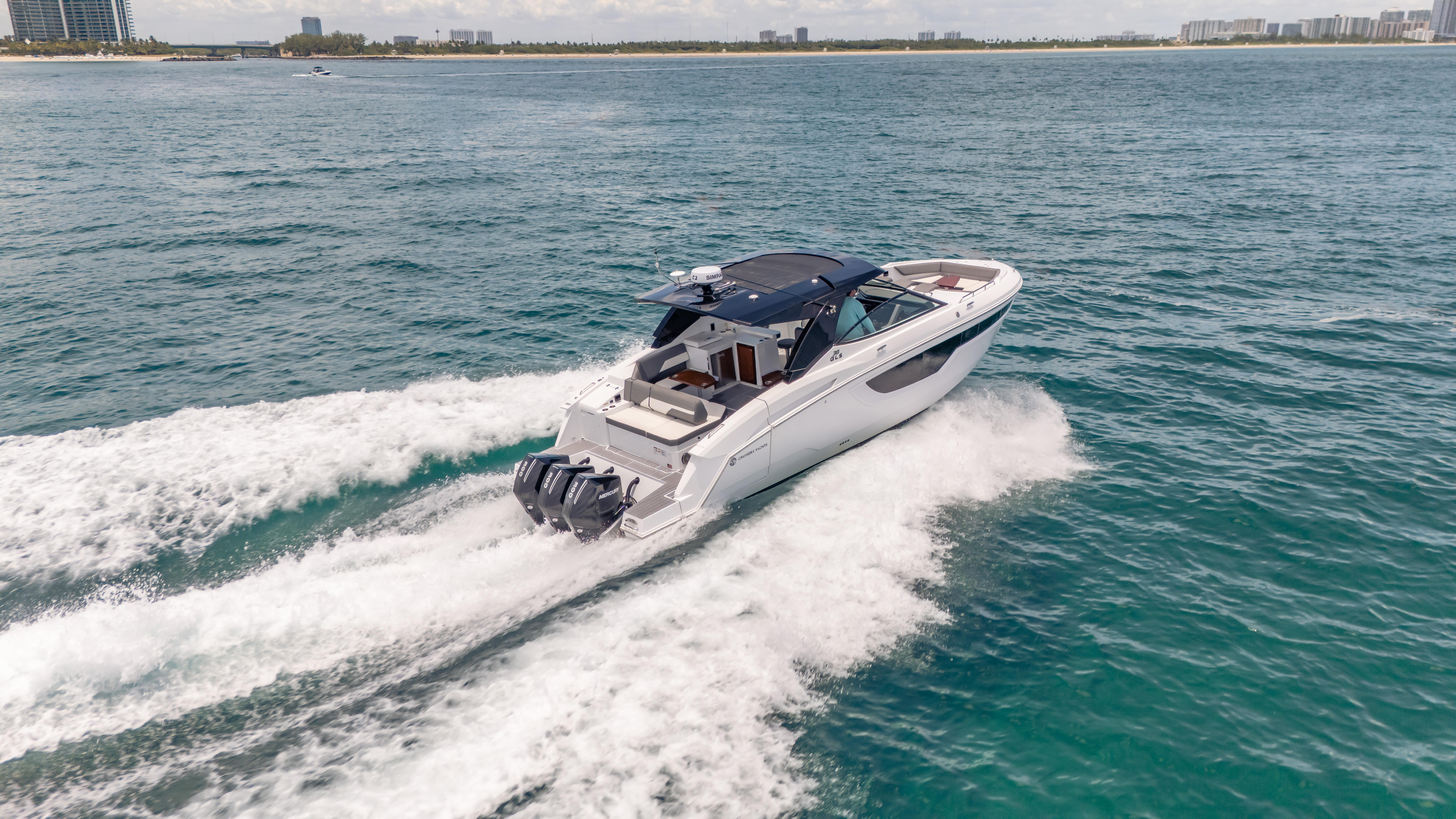 2021 Cruisers Yachts 38 GLS speeding on open water, showcasing sleek design and powerful engines.