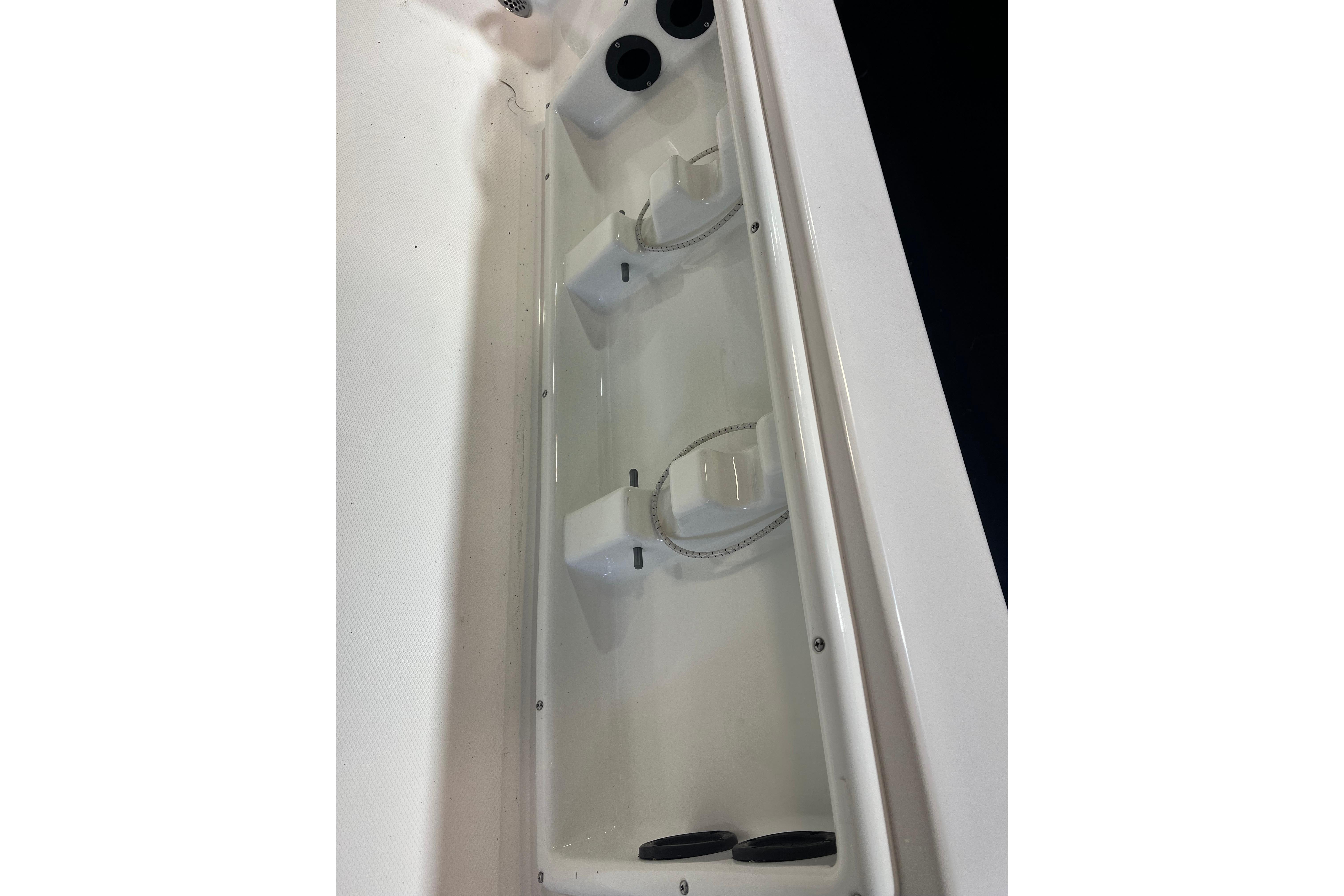 2023 NauticStar 227 XTS boat storage compartment with rod holders.
