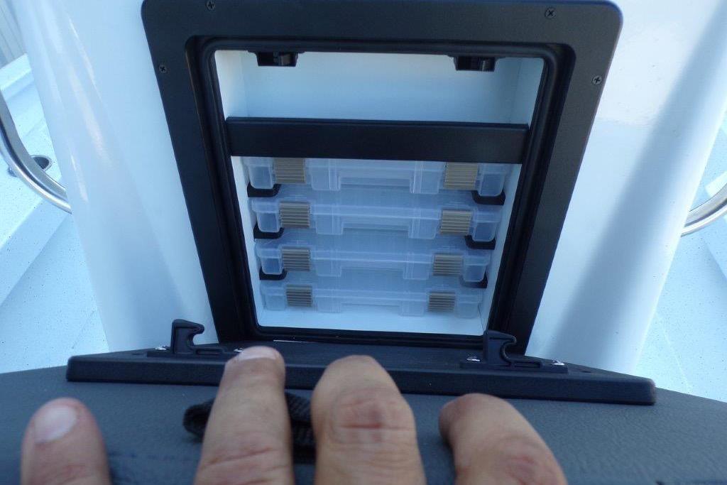 Storage compartment on 2026 Xpress H20B Bay boat with tackle boxes visible.