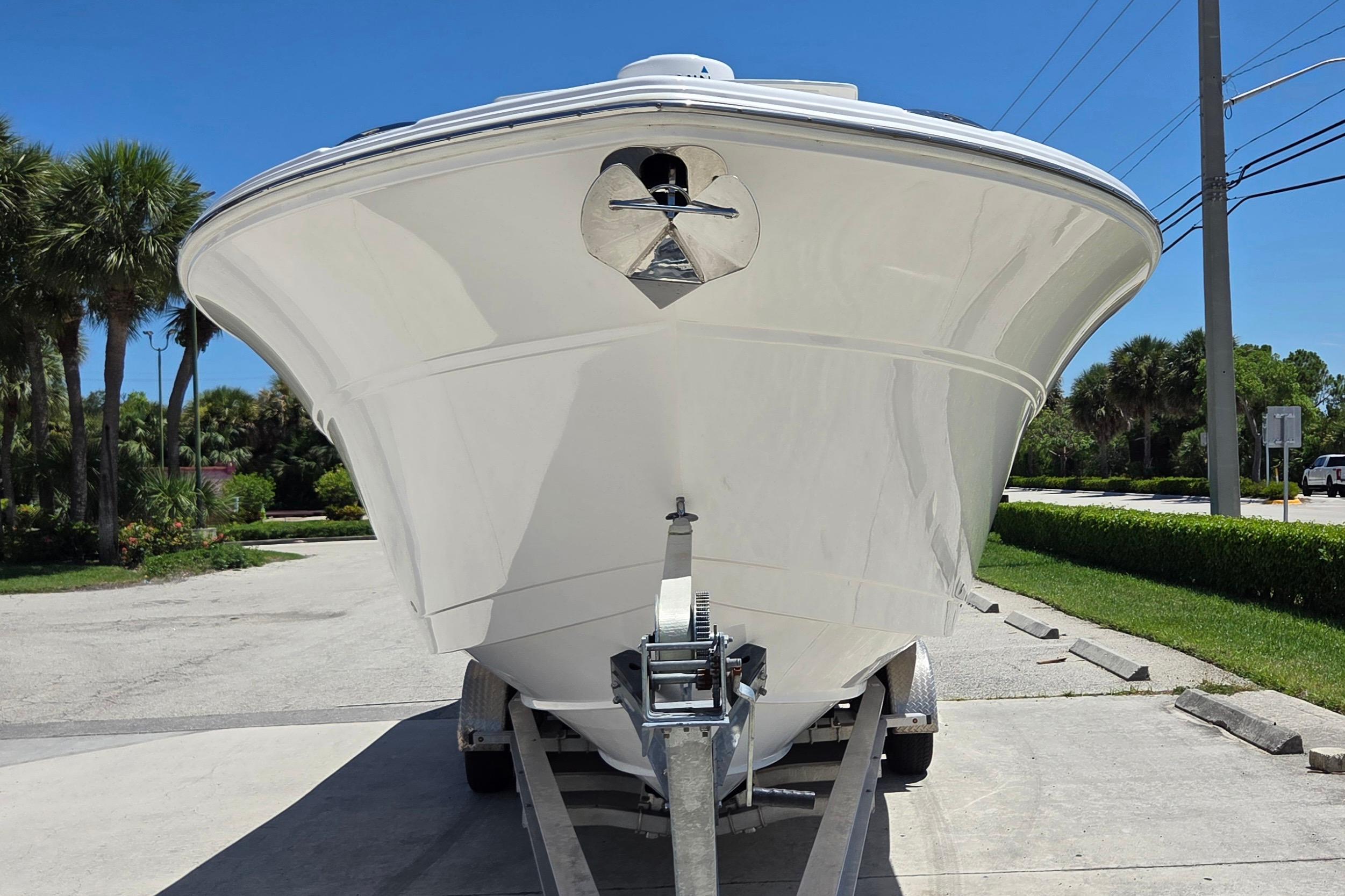 2021 Sea Fox 328 Commander boat on trailer, parked outdoors under clear blue sky.