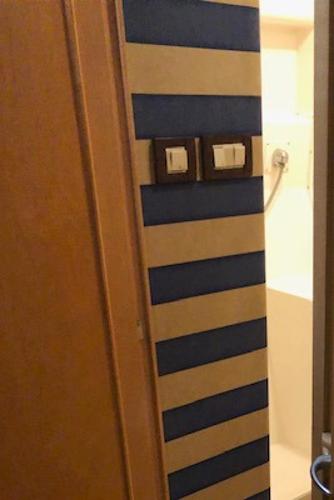 1997 Bertram Convertible interior with striped wall and light switches.