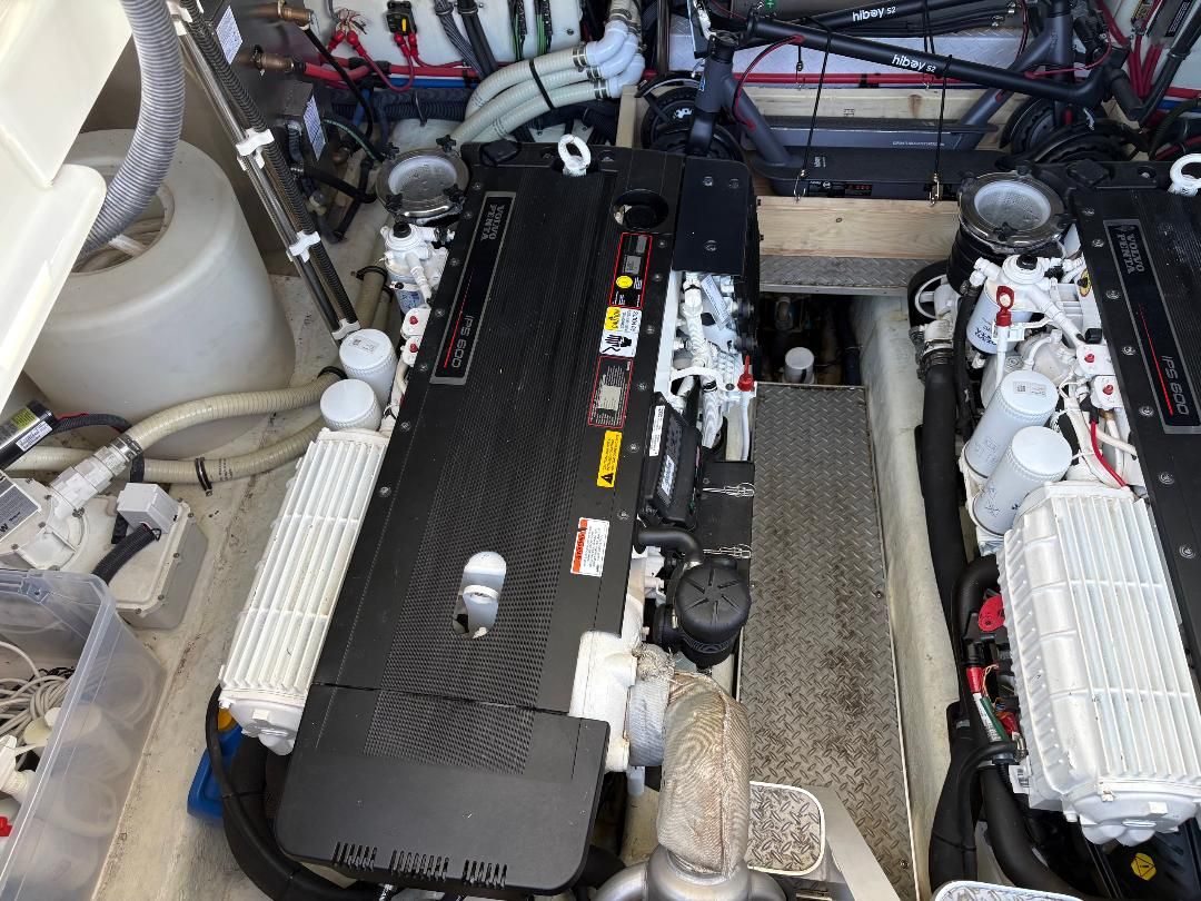 Engine room of a 2011 Formula 45 with two large engines and various hoses and cables.