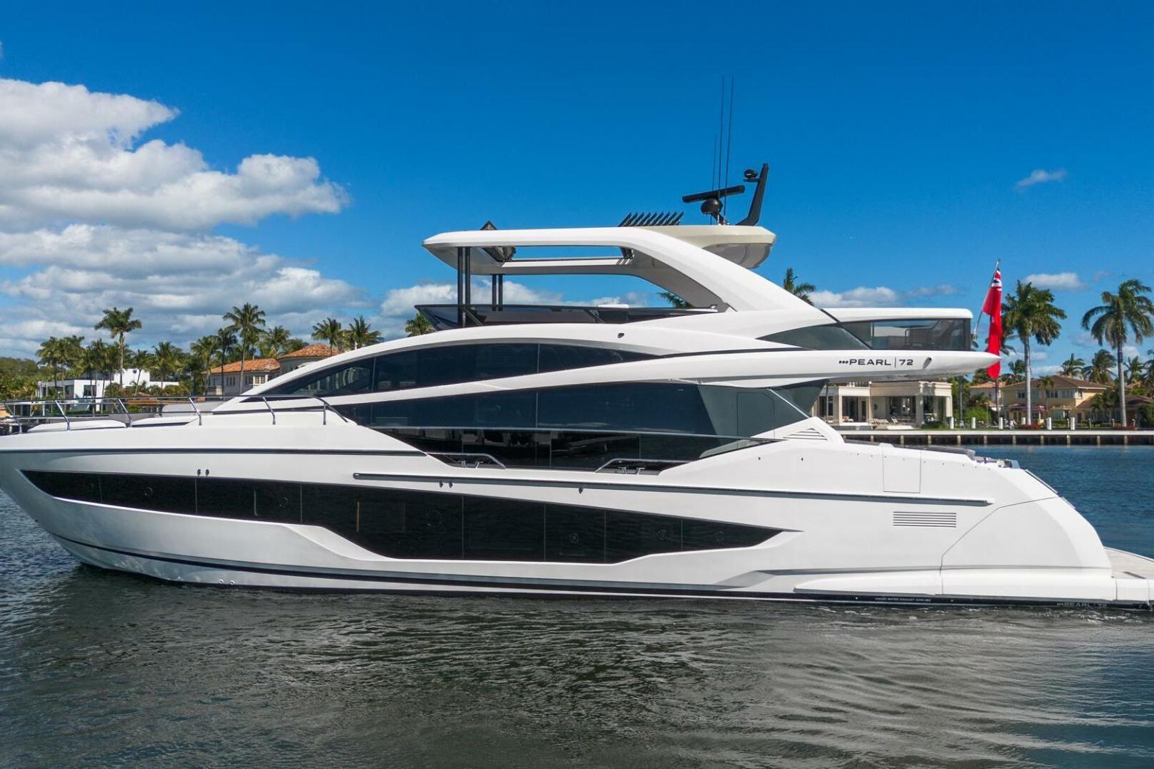 Luxurious 2023 Pearl 72 yacht cruising on a sunny day with palm trees in the background.