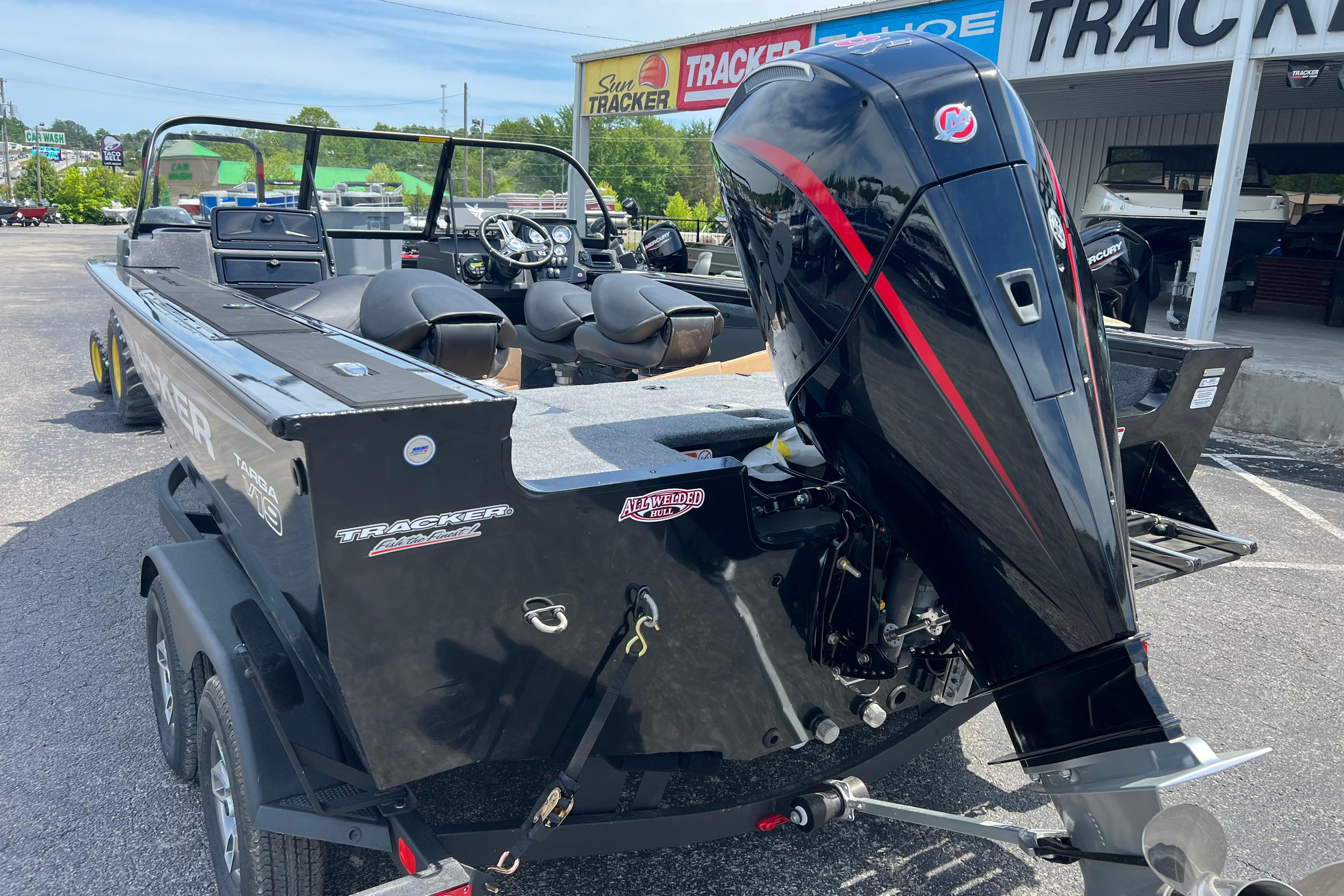 2026 Tracker Targa V-19 Combo boat with powerful outboard motor in dealership lot.