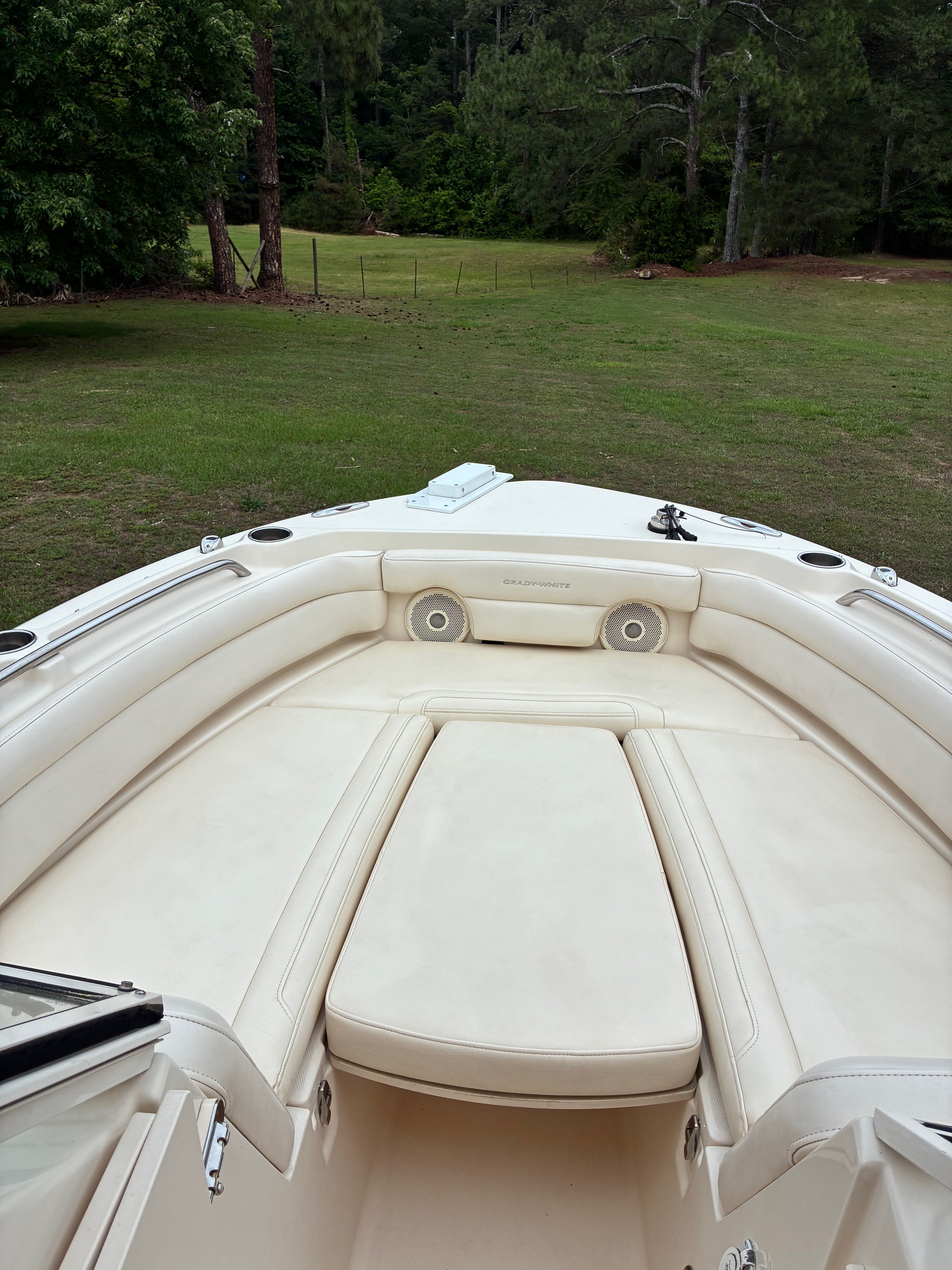 Interior view of a 2018 Grady-White Freedom235 boat with beige upholstery.
