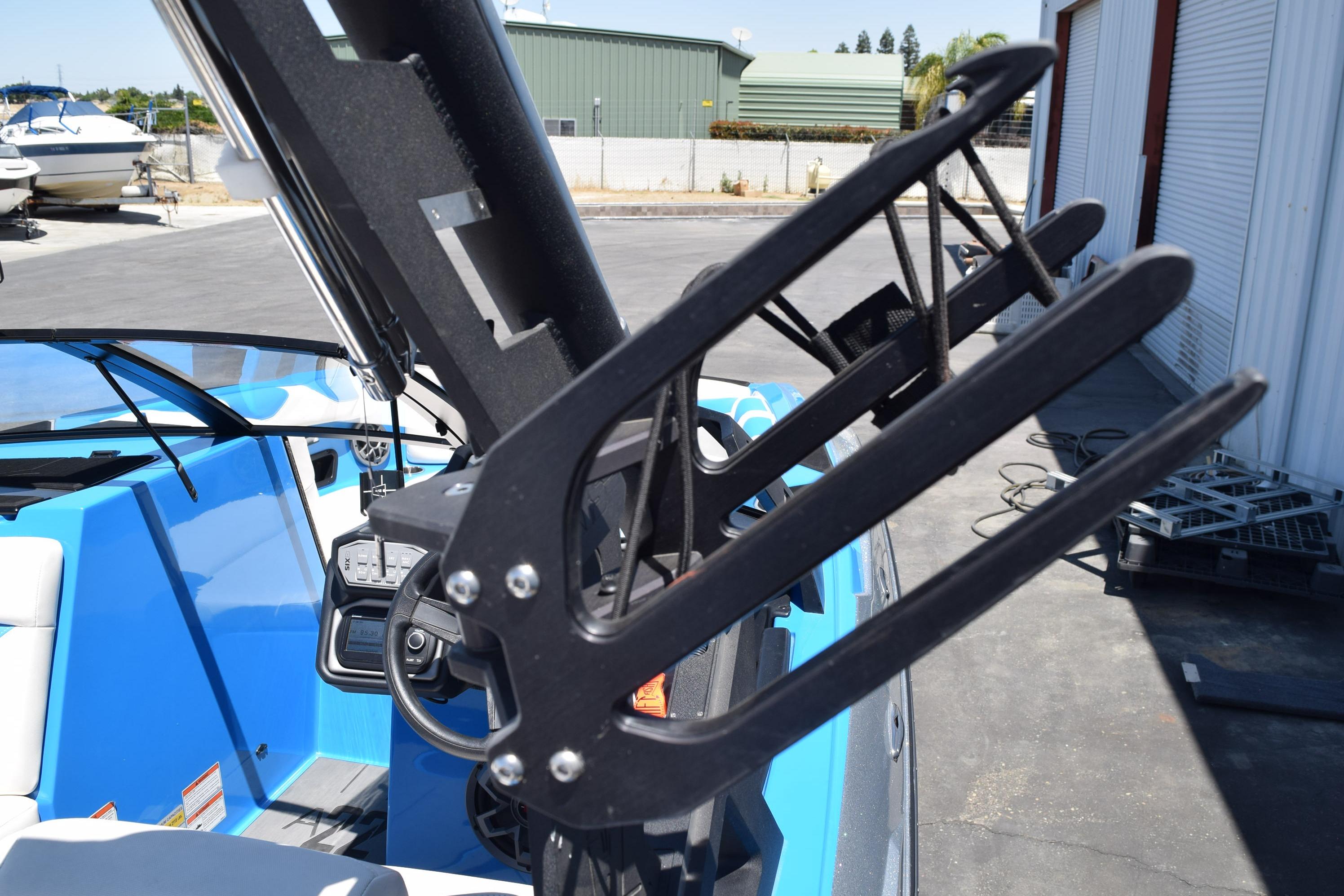 2019 Axis A22 boat with wakeboard rack and blue interior.