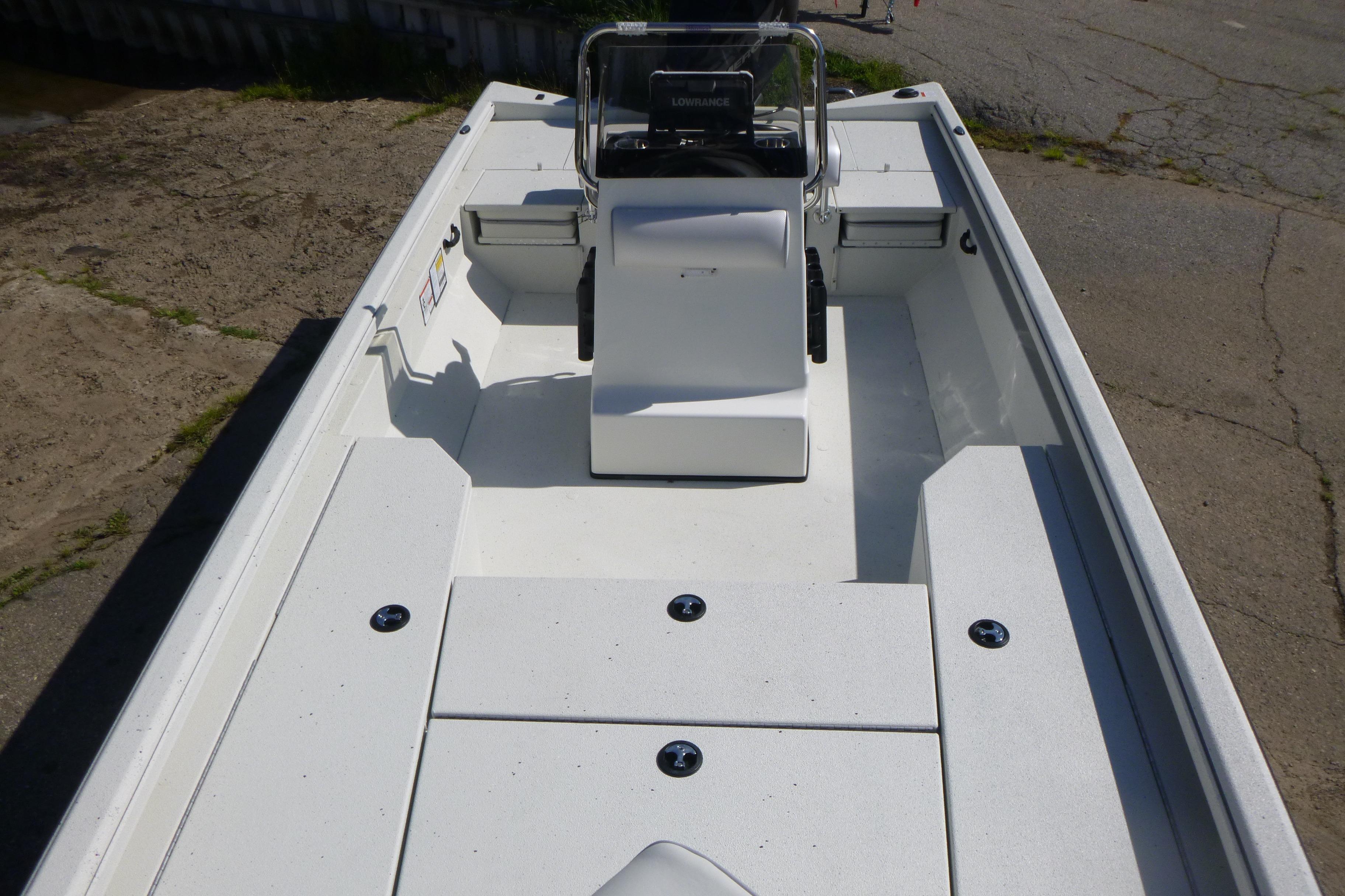 2025 Ranger RB210 boat interior with center console and seating, docked on concrete.