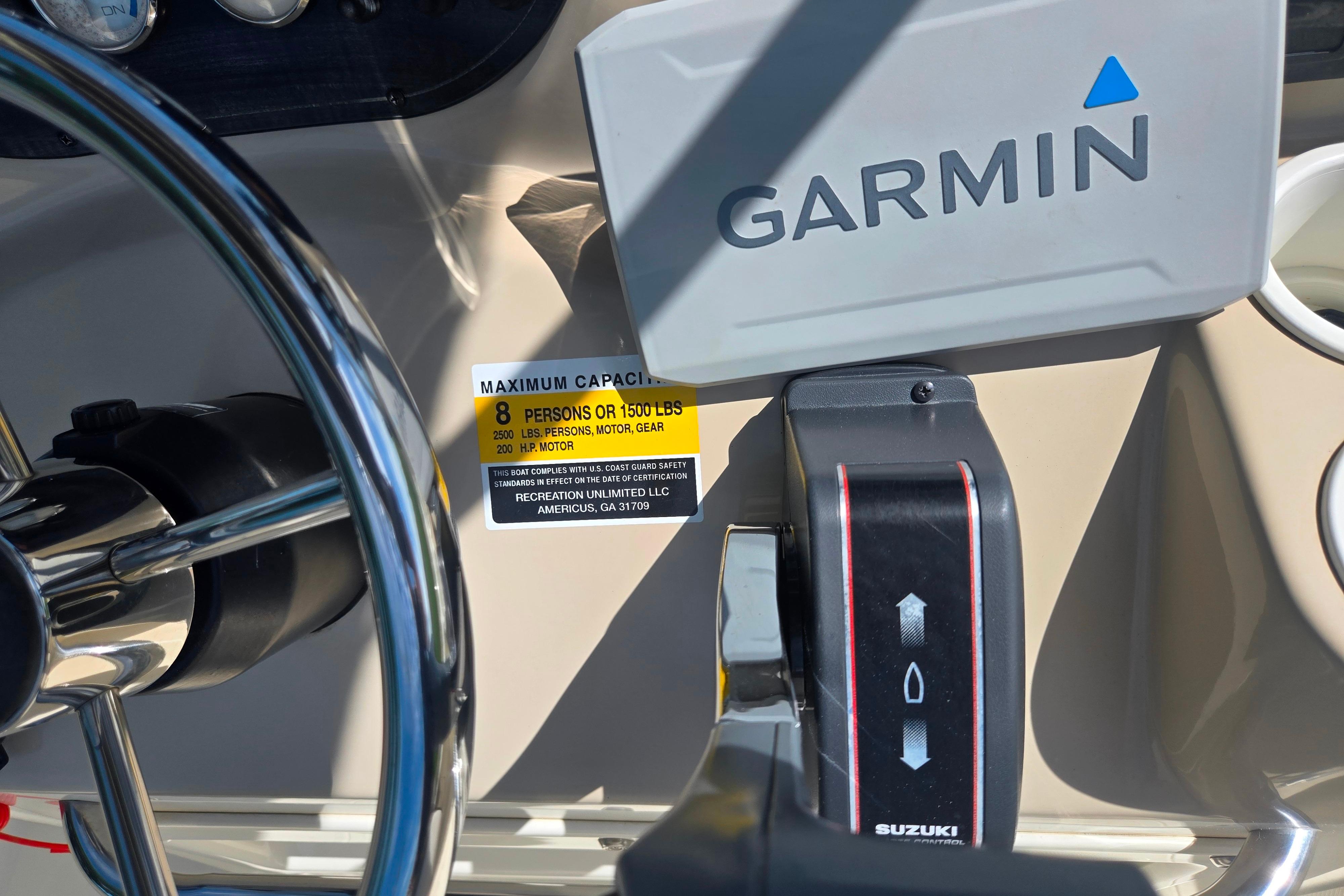 Boat dashboard with Garmin GPS, Suzuki throttle, and capacity label on Key Largo 2000CC, 2016 model.