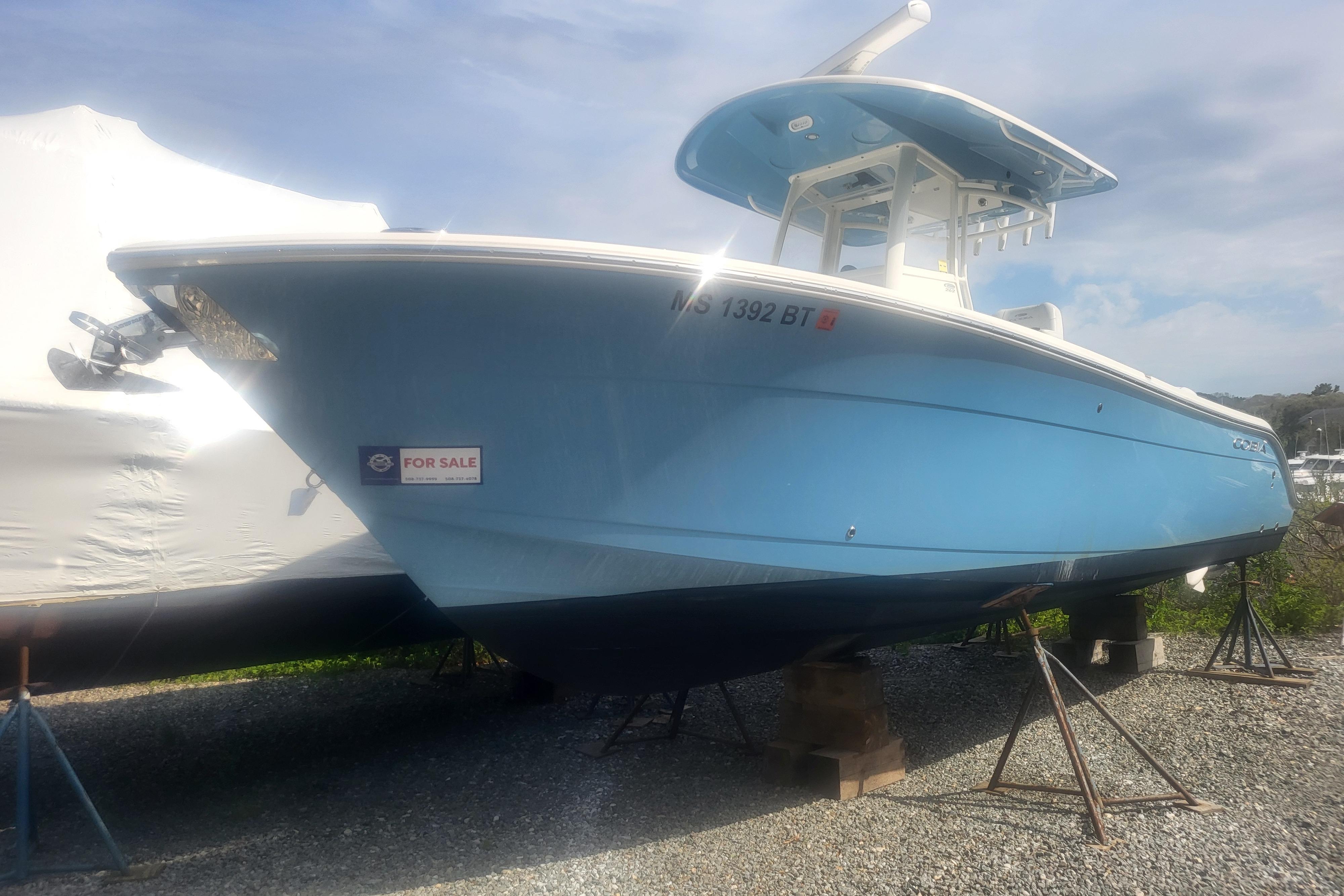2022 Cobia 262 Center Console boat for sale, displayed on stands outdoors.