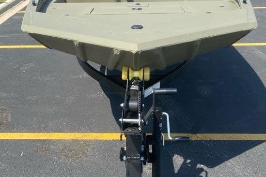 2026 Tracker Grizzly 1648 SC boat on trailer, parked in a lot.