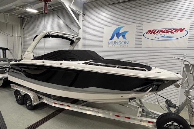 2026 Chaparral SSX 8 boat on trailer in showroom, Munson Marine signage visible.
