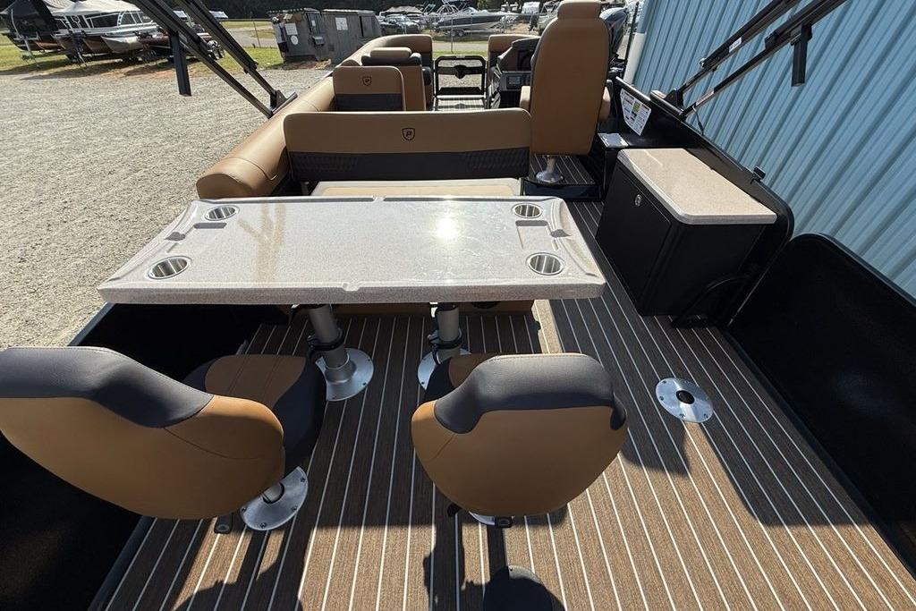 Luxurious interior of 2026 Premier 250 Solaris RS CL pontoon boat with seating and table.