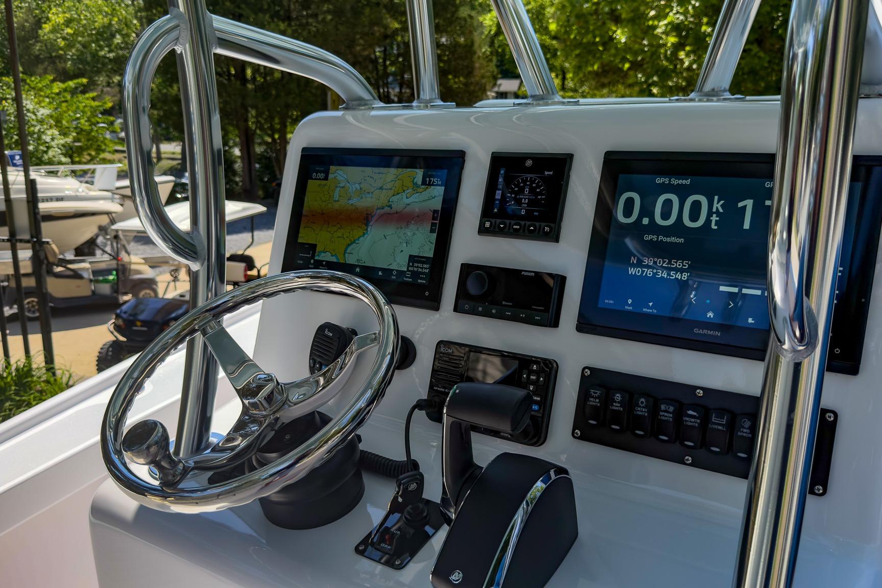 Control panel of a 2025 Weaver 25 boat with GPS and navigation screens.