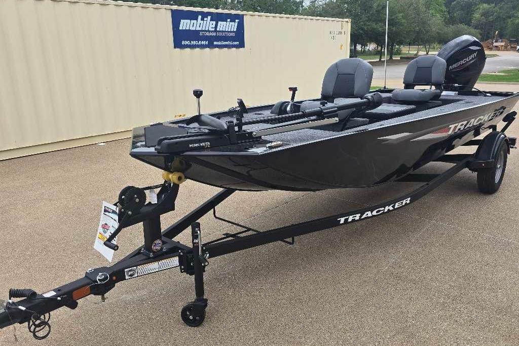 2026 Tracker Panfish 17 boat on trailer, parked outdoors near storage container.