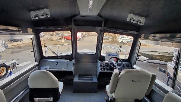 Interior view of 2023 Spartan 220 Maximus boat, featuring dual seats and control panel.
