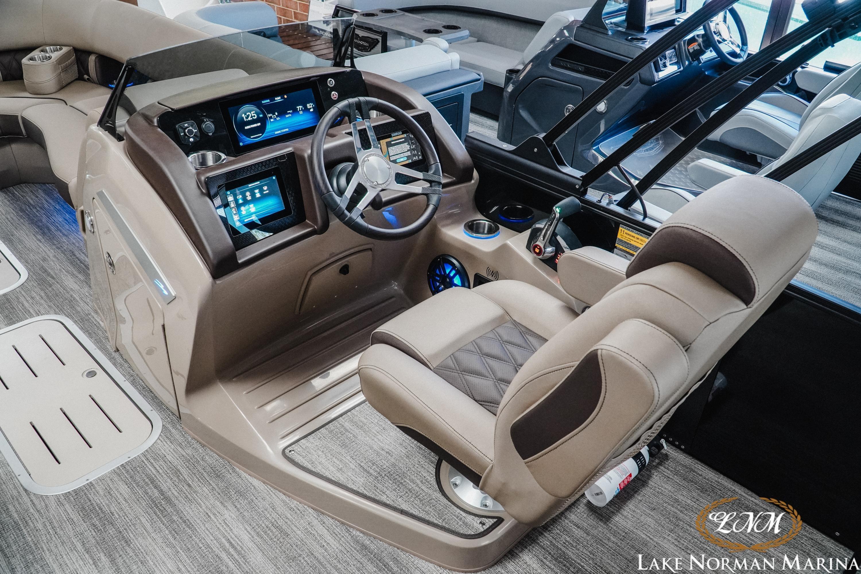 Interior of 2026 Bennington 24LXSSB boat with modern dashboard and luxurious seating.