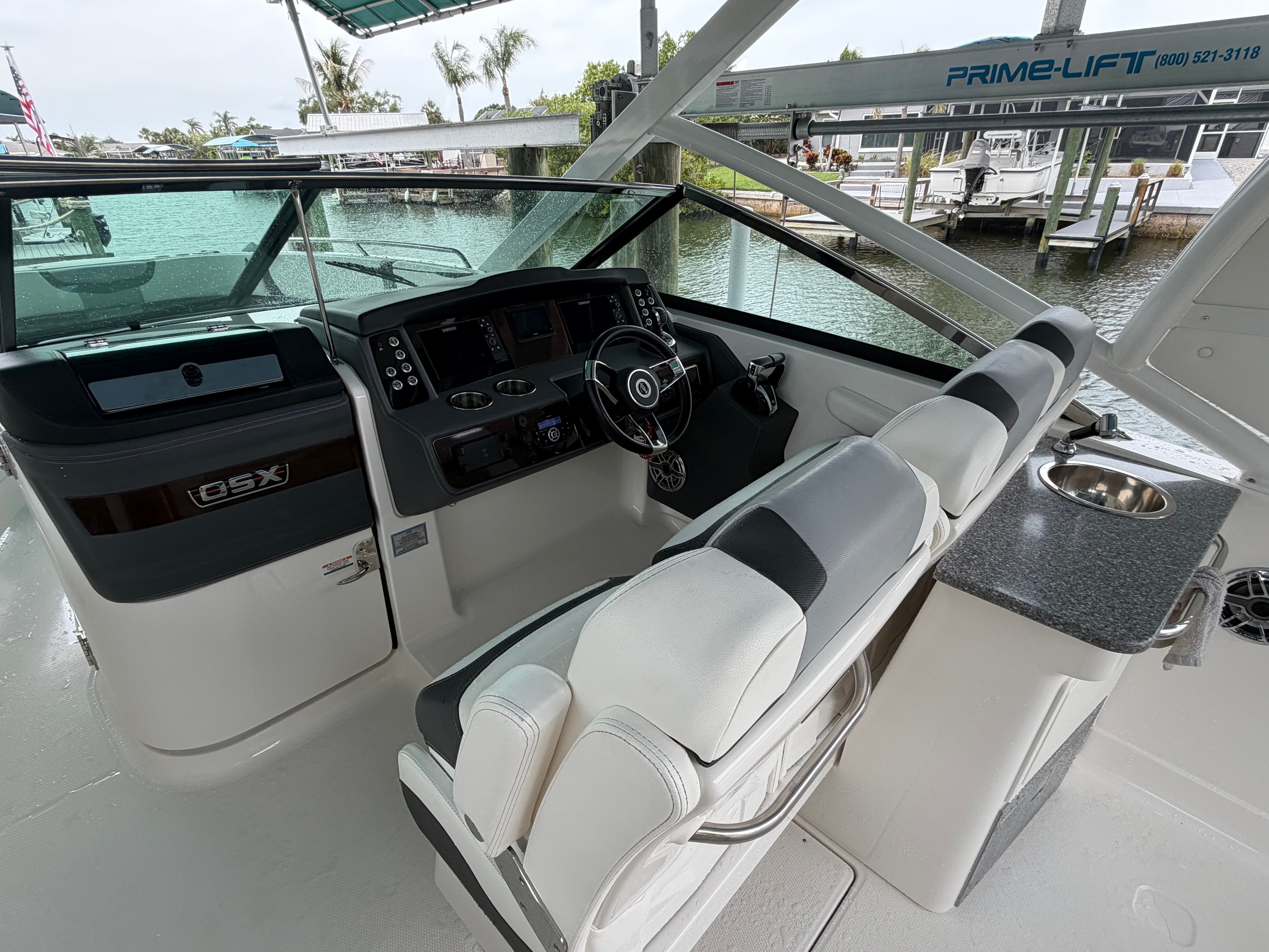 The cockpit of a modern boat with a helm and seating area.