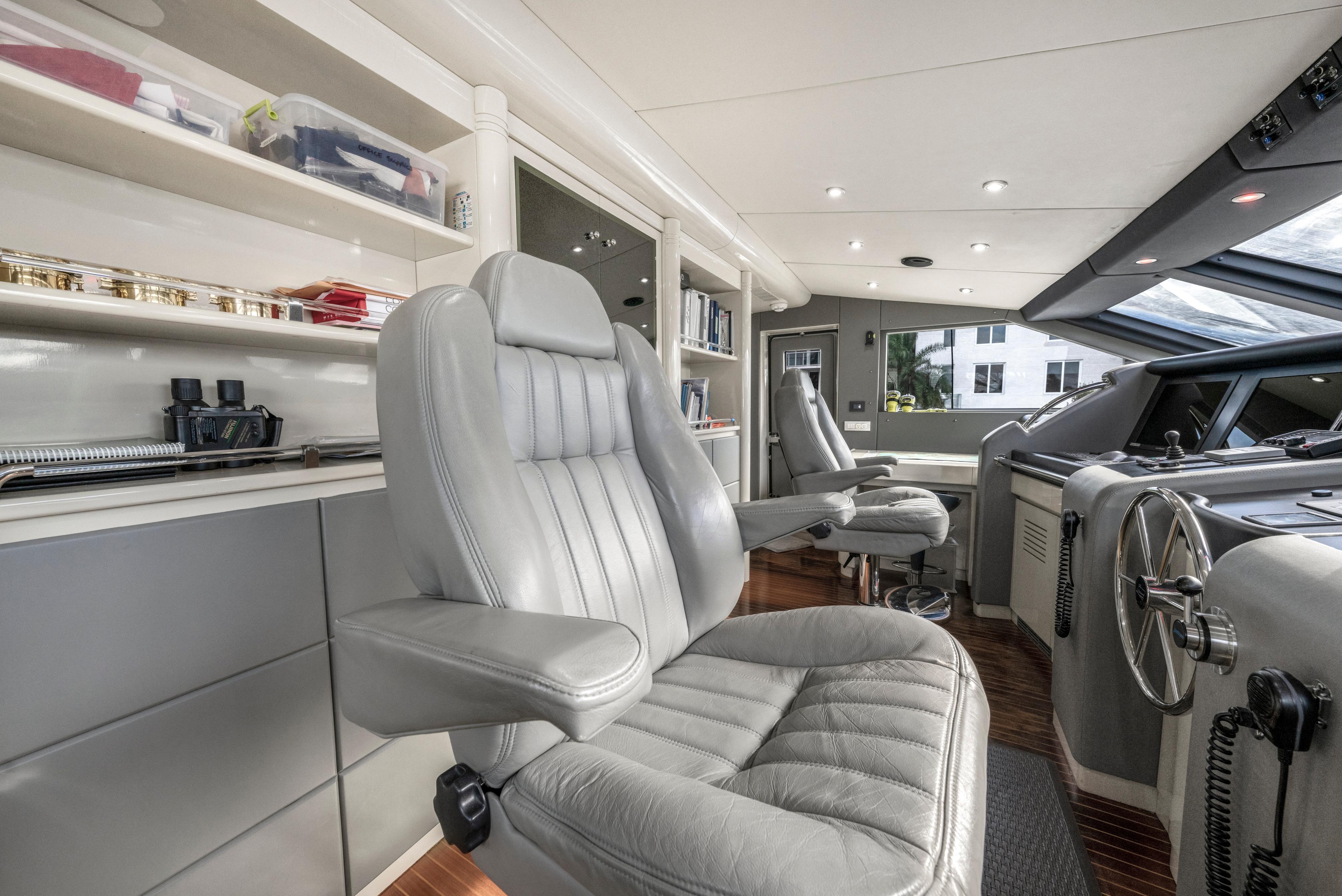Luxurious 1998 Intermarine 118 yacht interior with plush seating and modern helm controls.