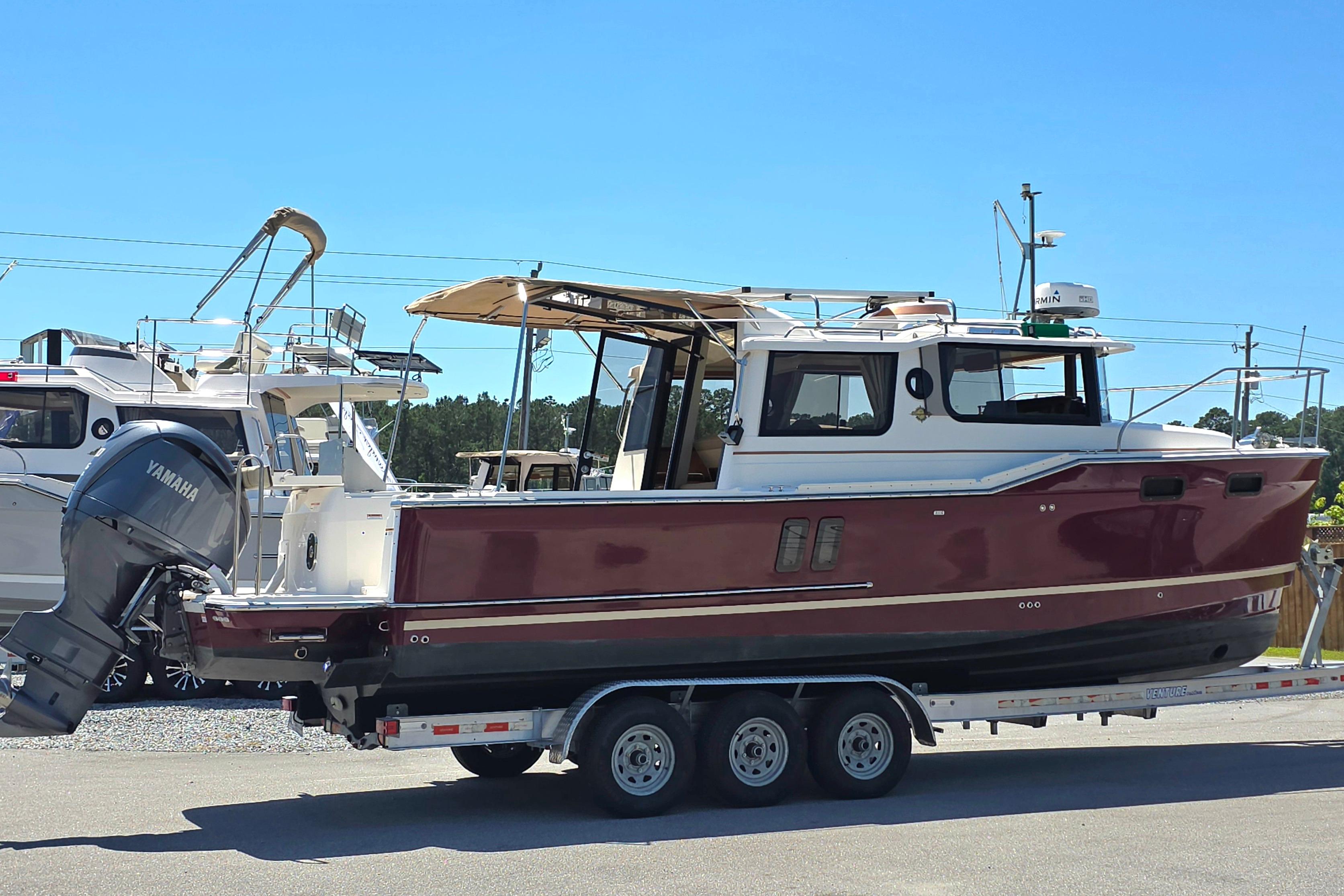 2021 Ranger Tug R27 boat on trailer with Yamaha outboard motor.