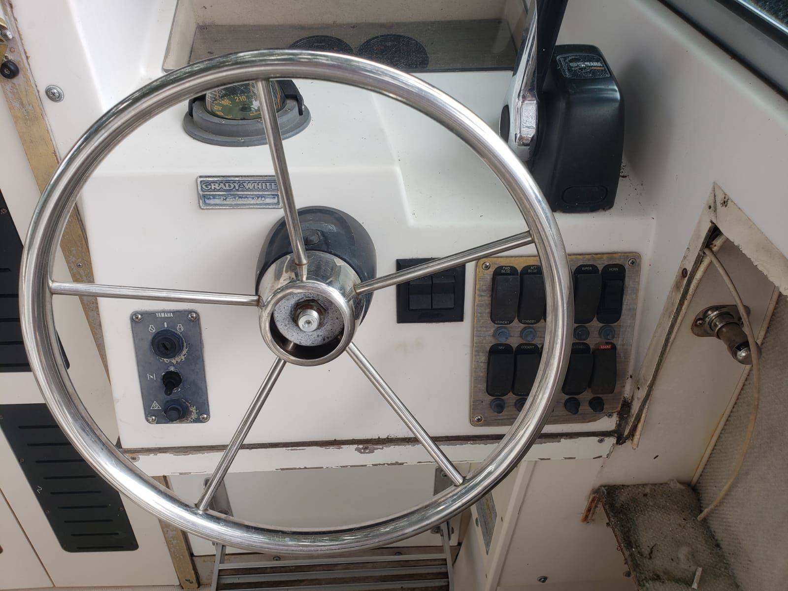 The image shows the helm of a 1995 Grady-White Explorer 24 with instruments and switches.