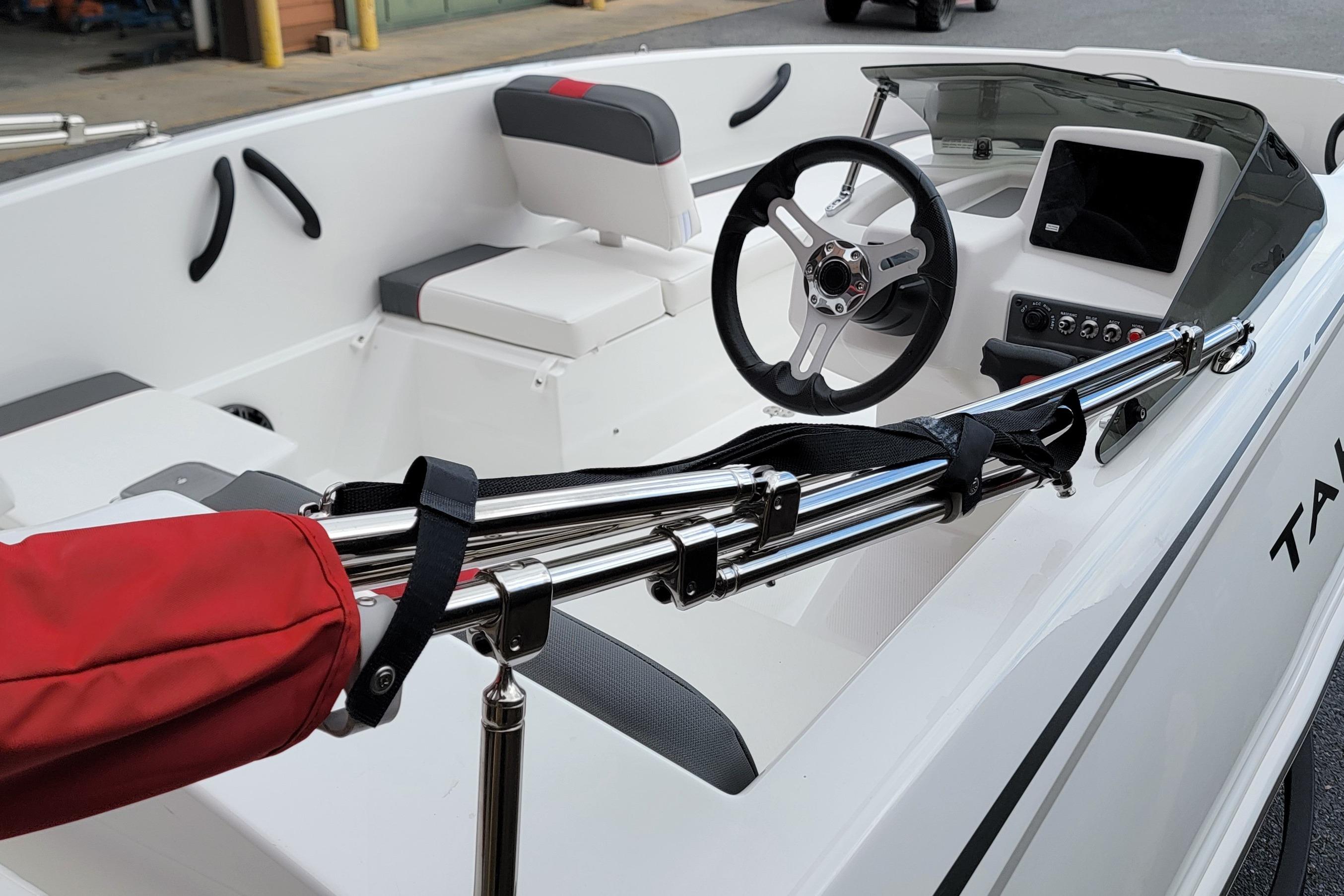2026 Tahoe T16 boat interior with steering wheel, seating, and control panel.