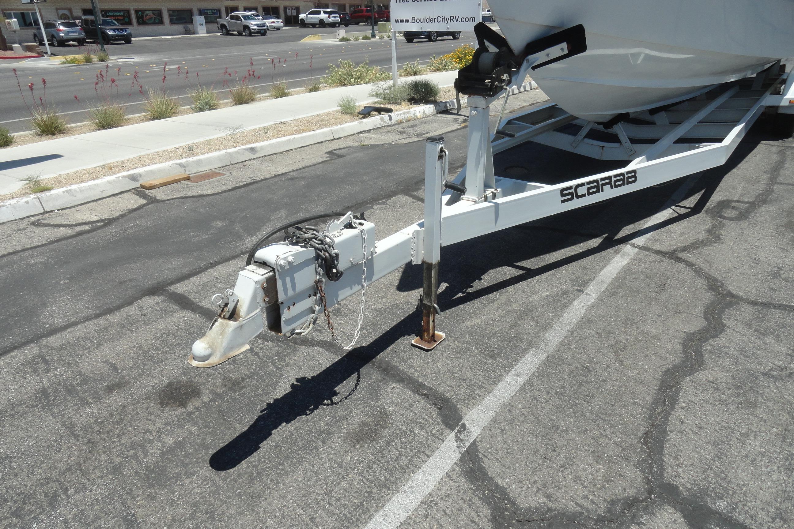 Trailer hitch of a 1988 Wellcraft 34 Scarab boat in a parking lot.