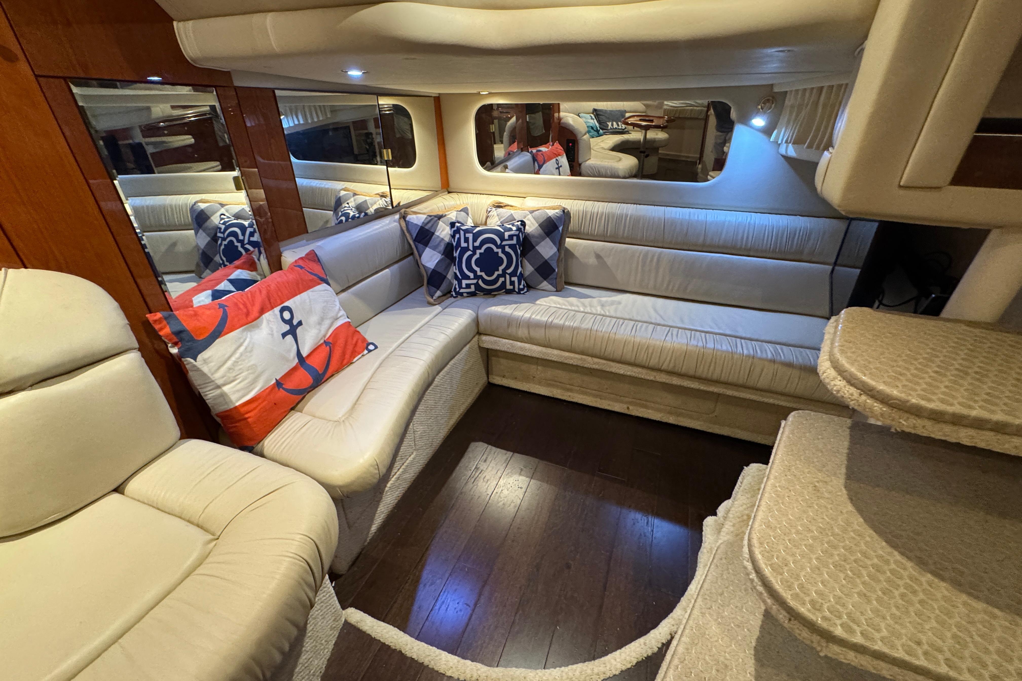 Luxurious interior of 2001 Sea Ray 380 Sundancer yacht with plush seating and nautical decor.
