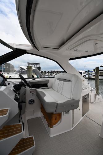 2021 Regal 35 Sport Coupe interior with helm seat, docked at marina.