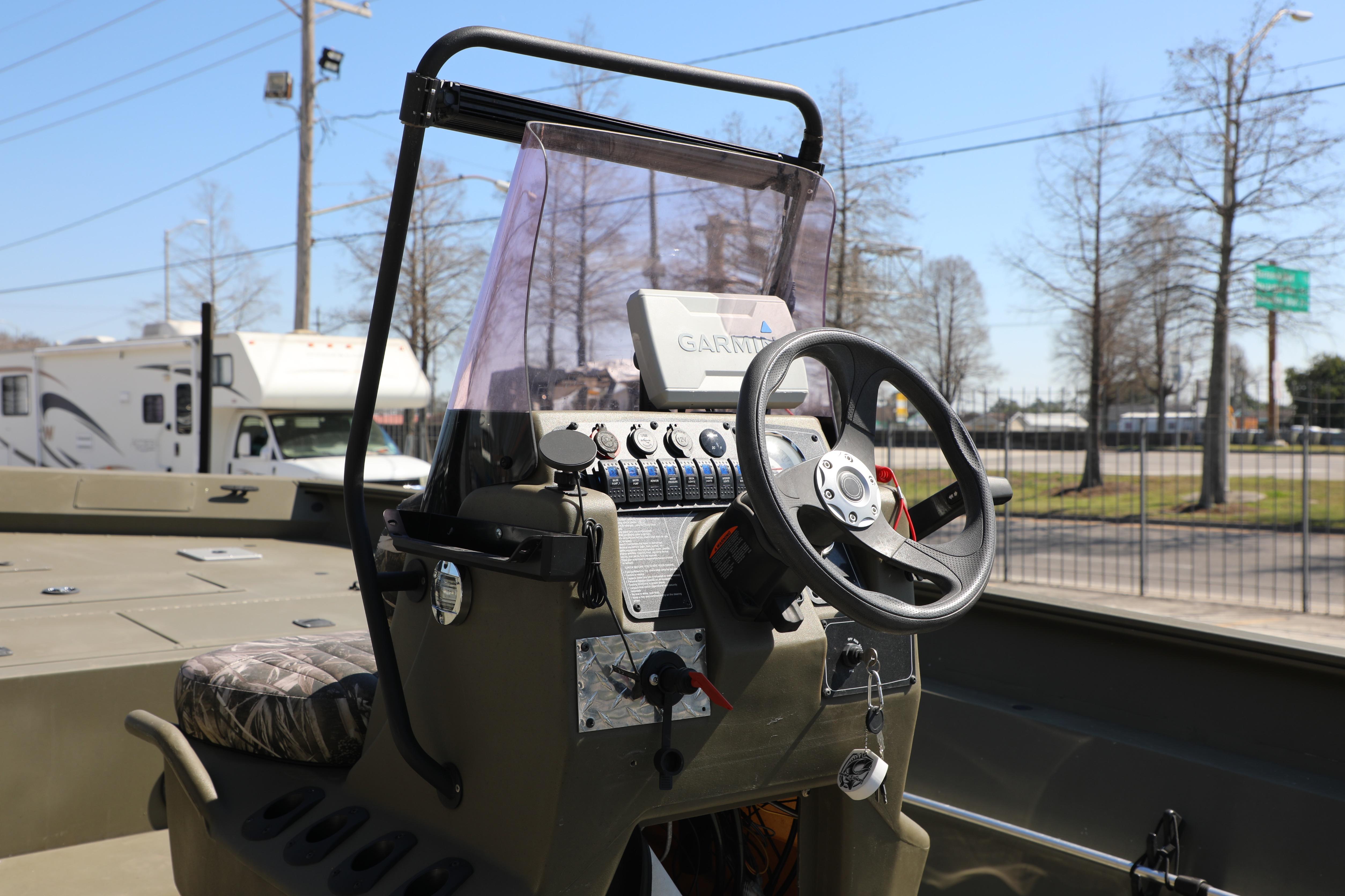2021 Tracker Grizzly 2072 SC boat console with steering wheel and Garmin device.