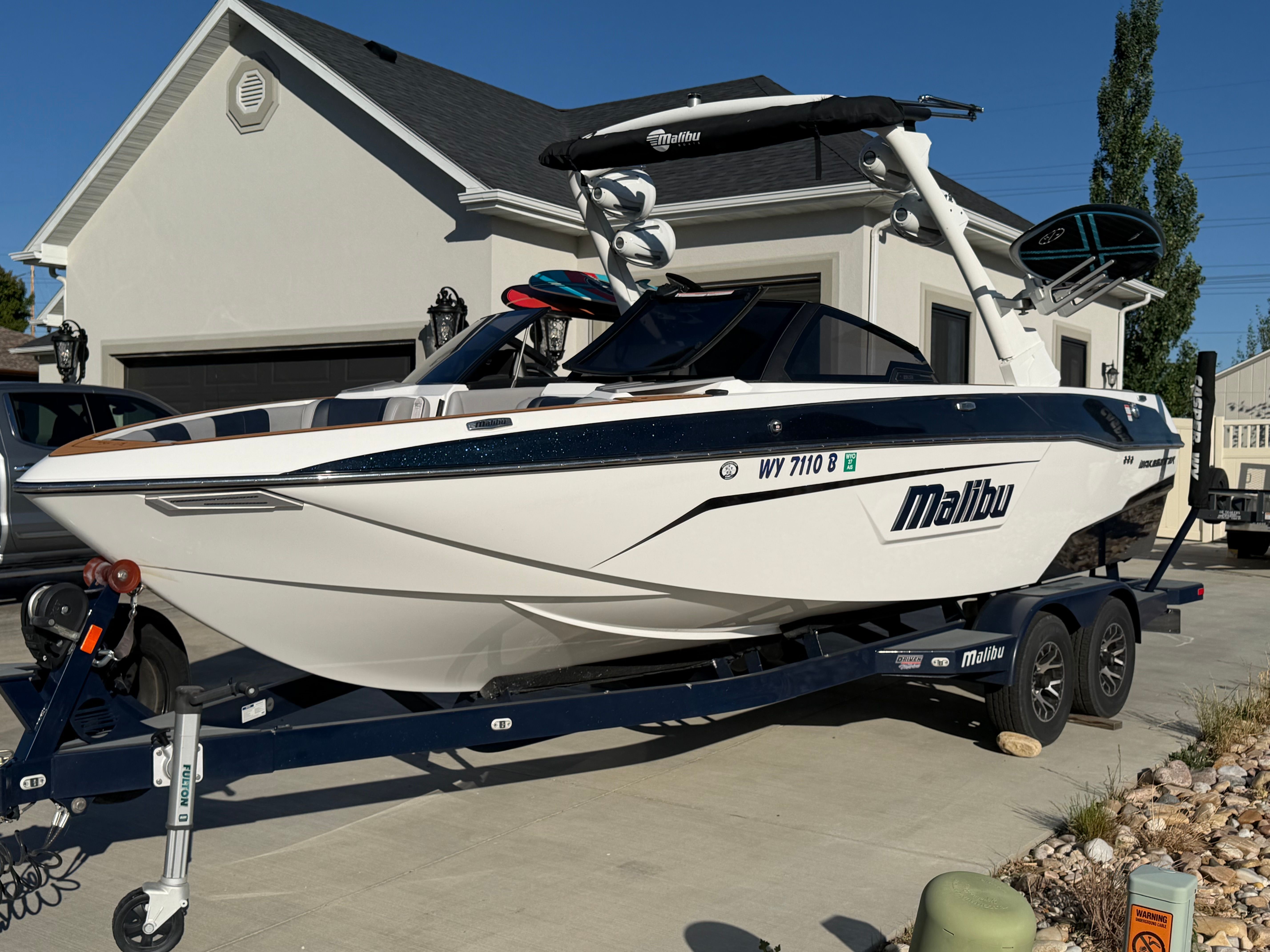 2021 Malibu Wakesetter 23 LSV parked in front of a house.