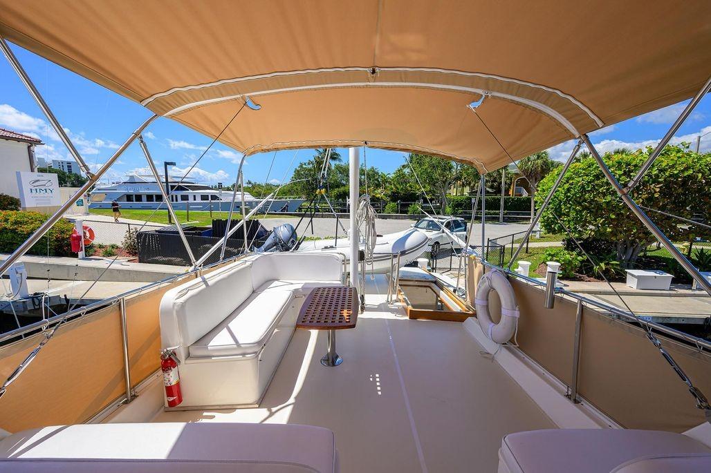 Spacious deck of 1999 Grand Banks 42 Europa yacht with canopy and seating.