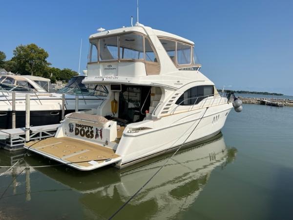 2009 Ovation 52 yacht docked at marina on a sunny day.