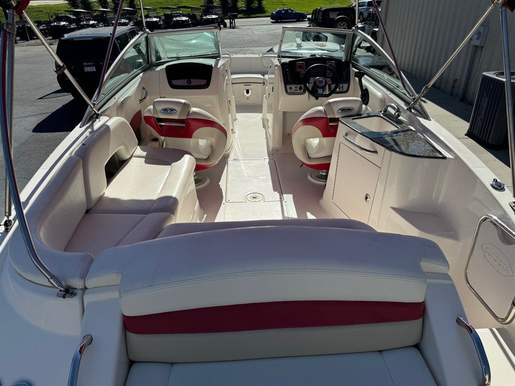 Interior view of a Chaparral Sunesta 244 boat with white and red seating.