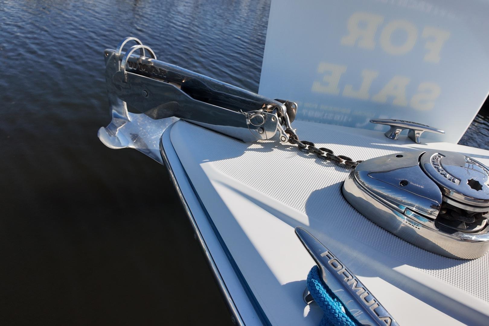 Bow of 2007 Formula 330 Sun Sport boat with anchor chain and "For Sale" sign.