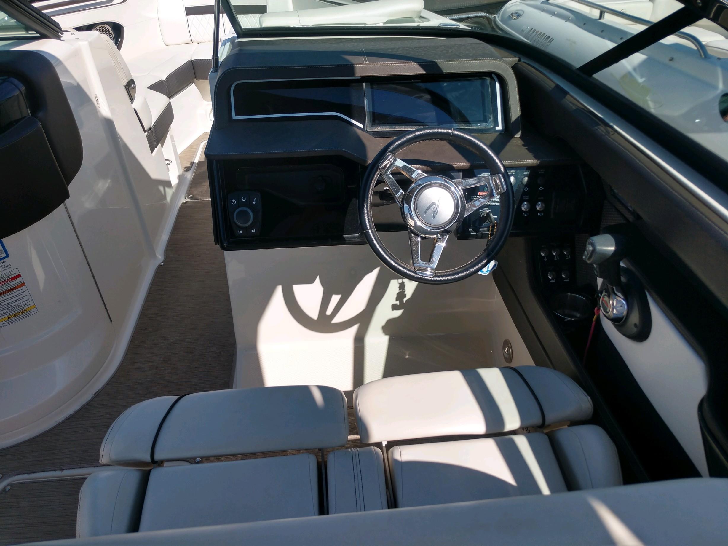 2018 Sea Ray SLX 280 boat cockpit with steering wheel and seating.