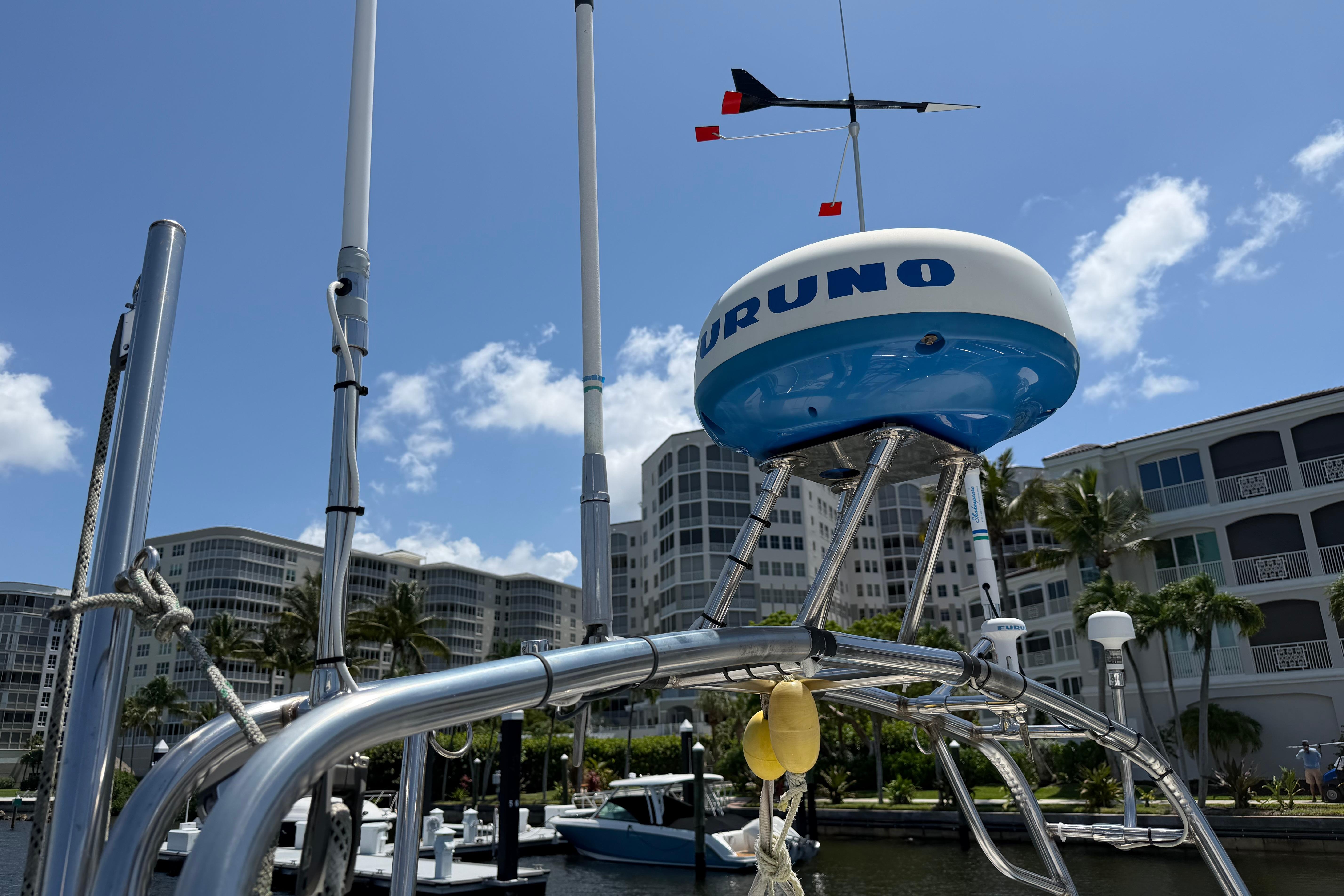 Radar equipment on a 1987 Moody 376 sailboat, docked near modern buildings.