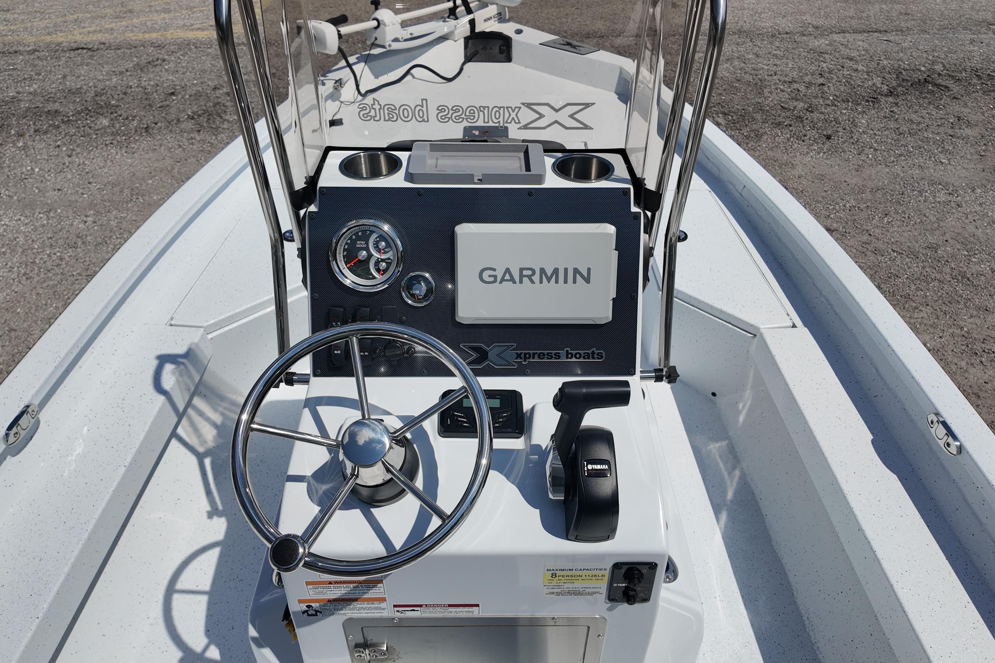Xpress H20 boat dashboard with Garmin system, steering wheel, and controls, 2026 model.