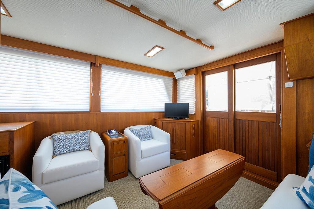 Interior of 1999 Grand Banks 42 Europa yacht with cozy seating and wooden accents.