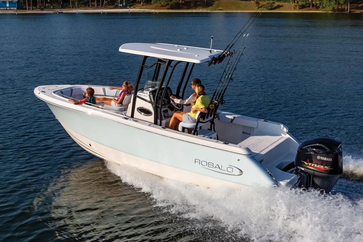 Manufacturer Provided Image: 2025 Robalo R232 Explorer boat cruising on a lake with passengers onboard.