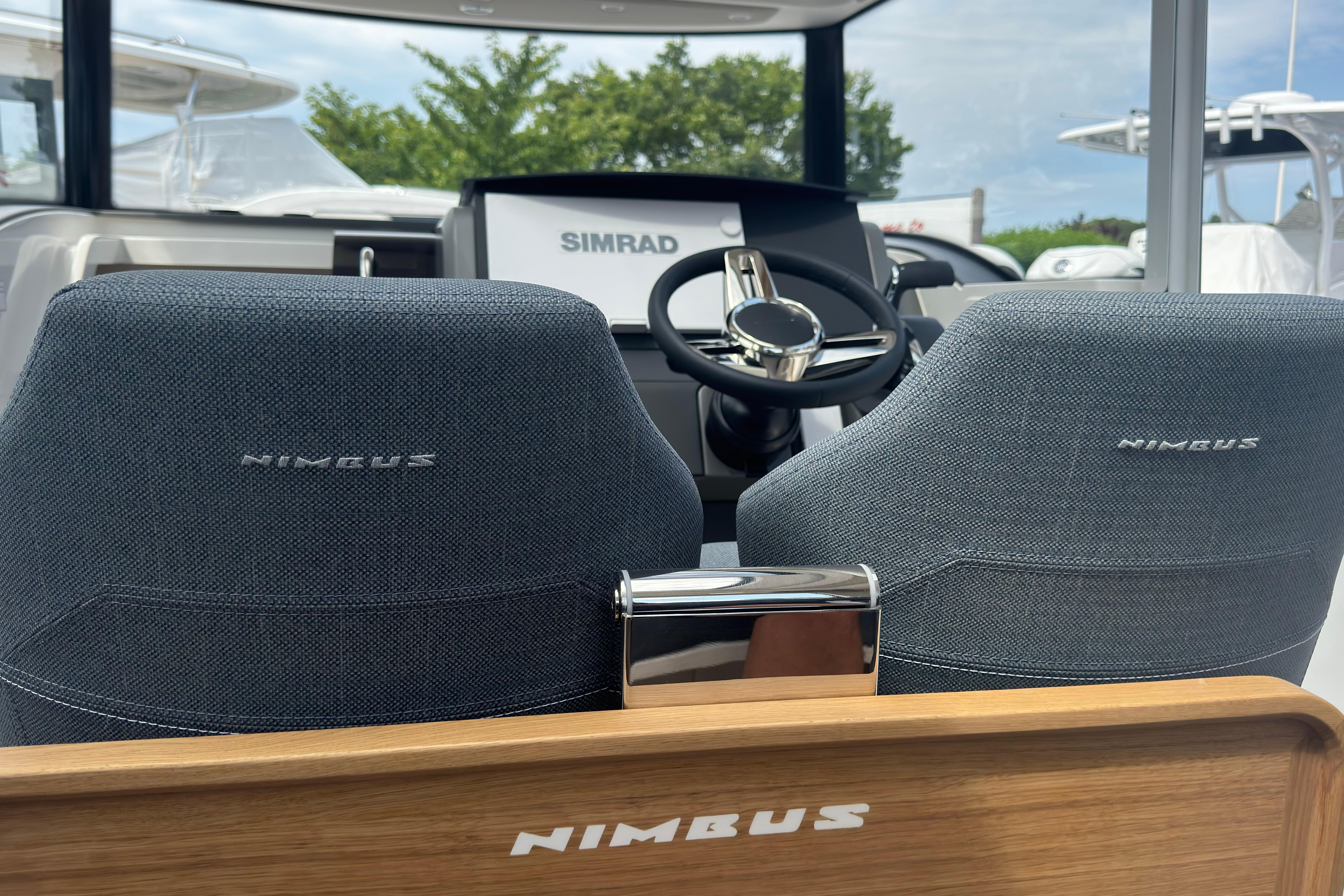 Interior of the Nimbus Commuter 9 with two seats and a modern helm station.