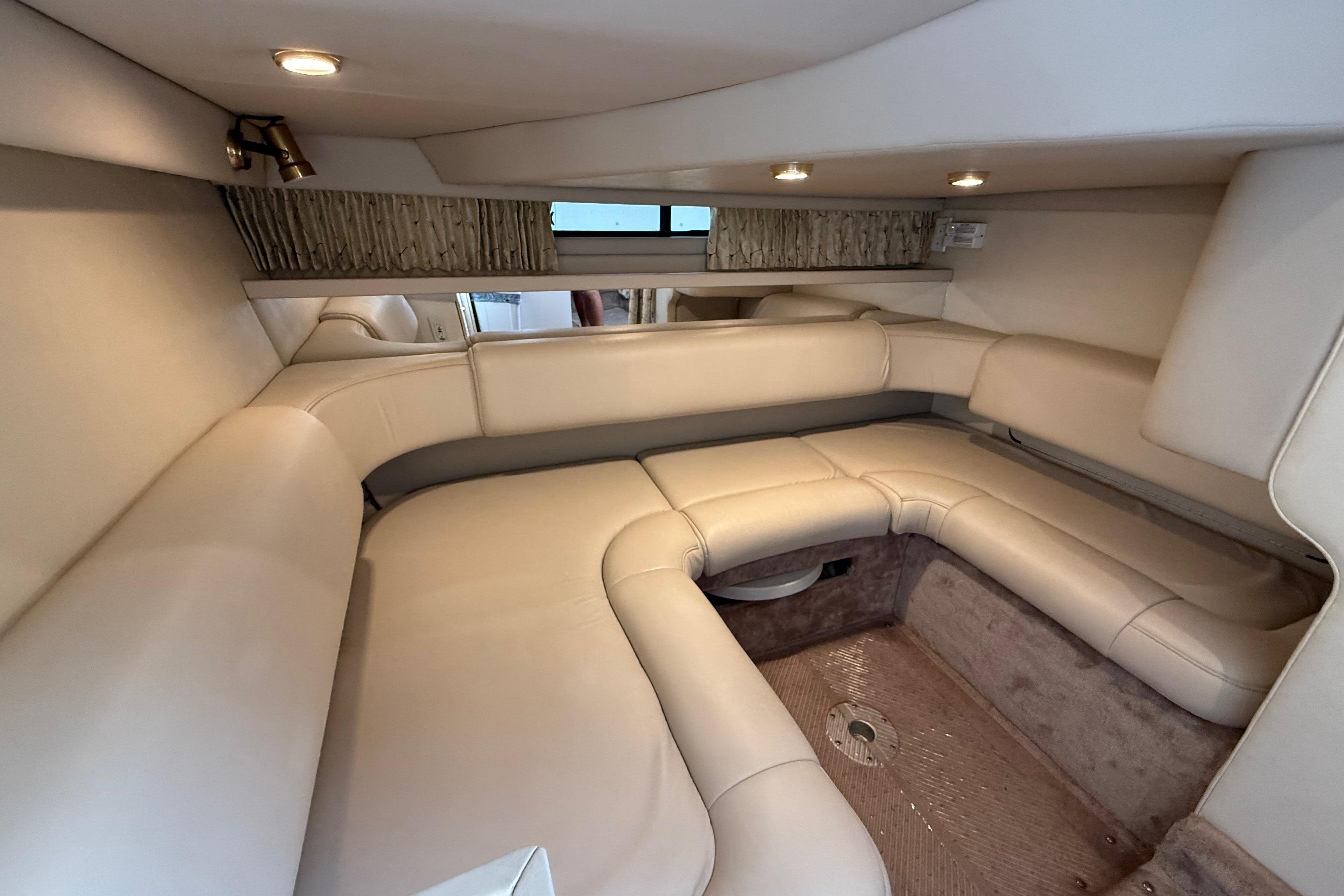 Interior of a 1999 Formula 34 Performance Cruiser with beige seating and ambient lighting.