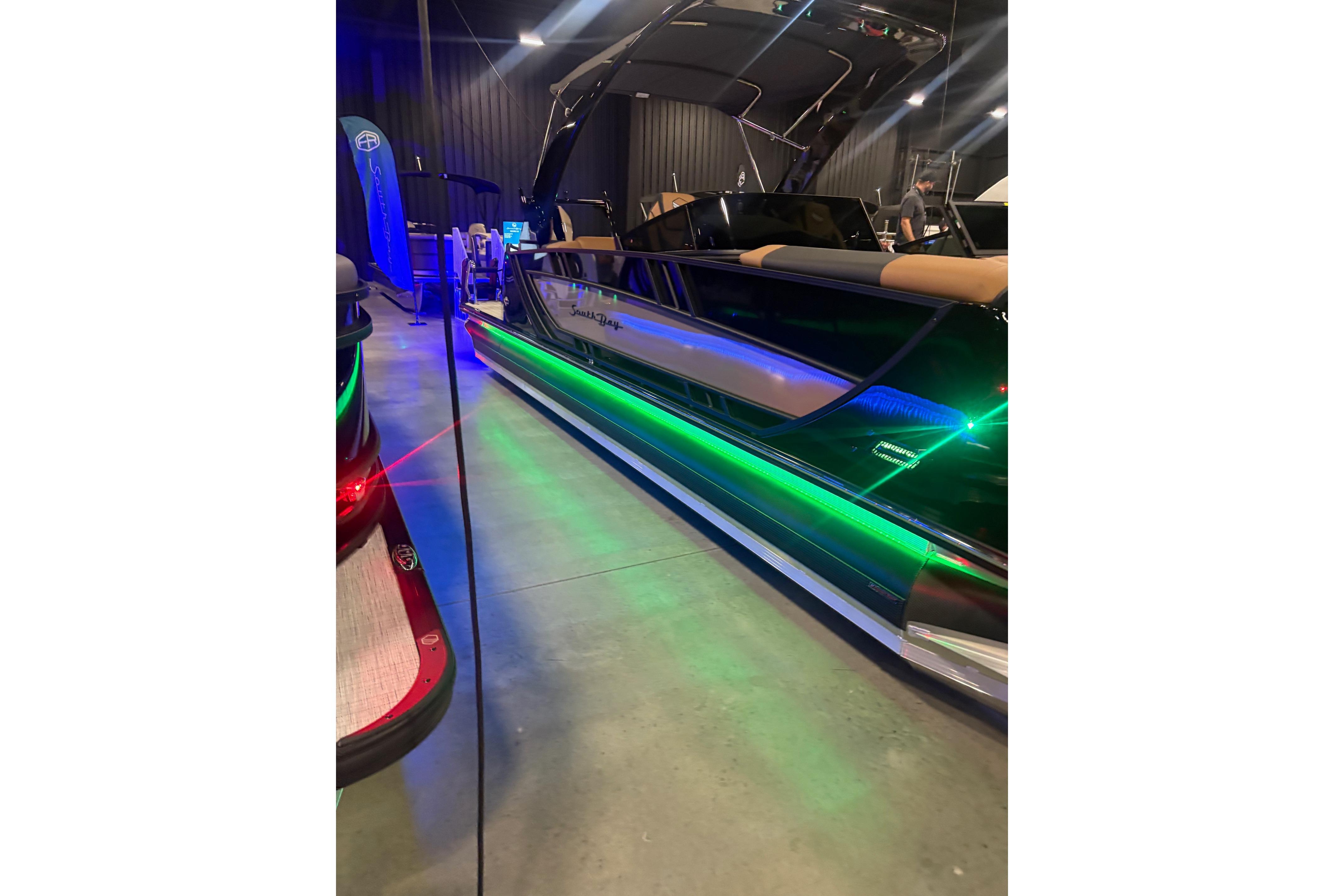 2026 South Bay Sport RS9 DC boat with vibrant LED lighting display.