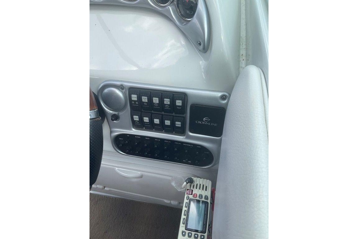 Control panel of 2015 Crownline 236 SC boat with switches and remote.