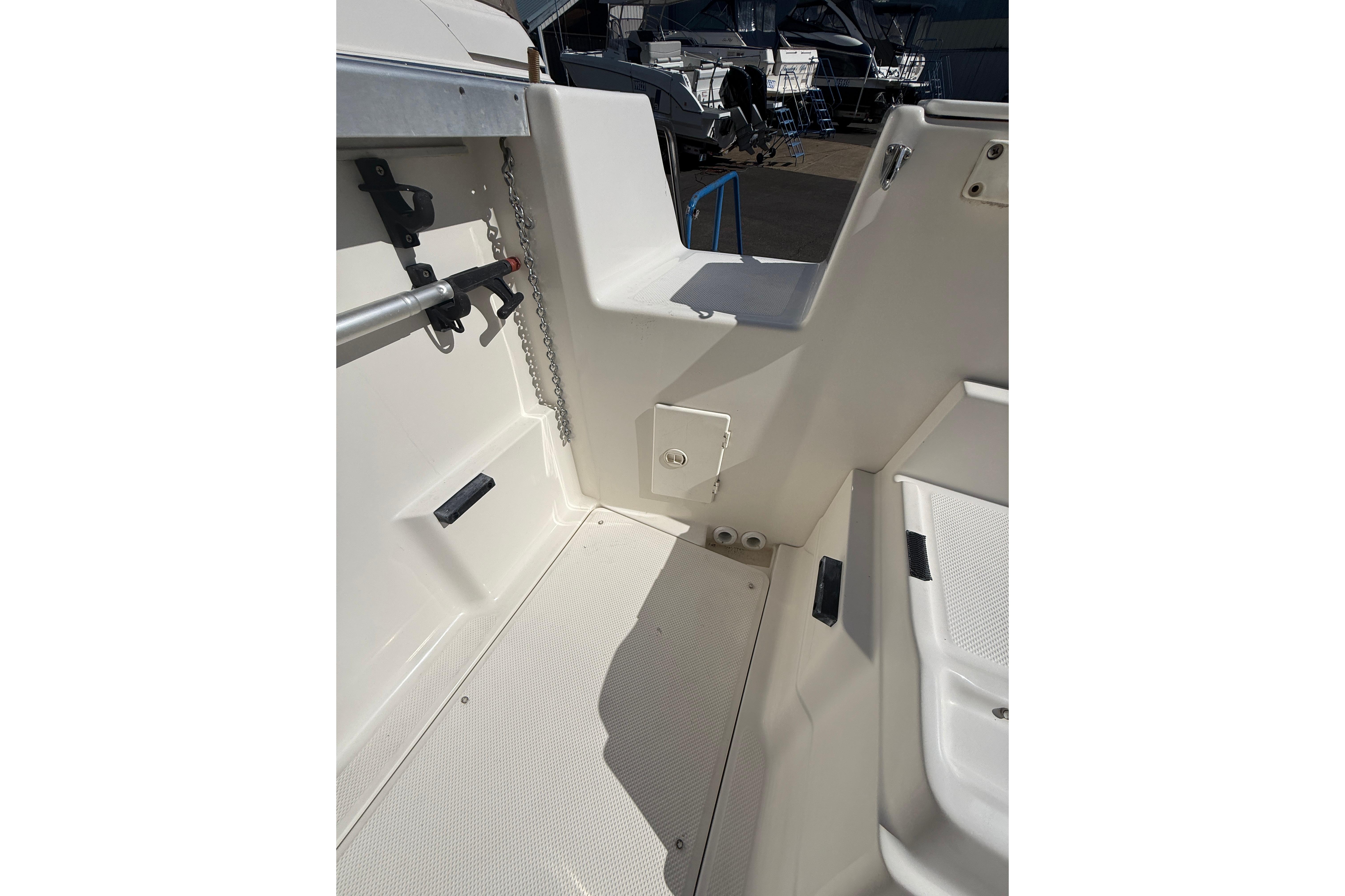 1997 Bayliner 2452 Ciera Express boat interior, showcasing clean white deck and seating area.