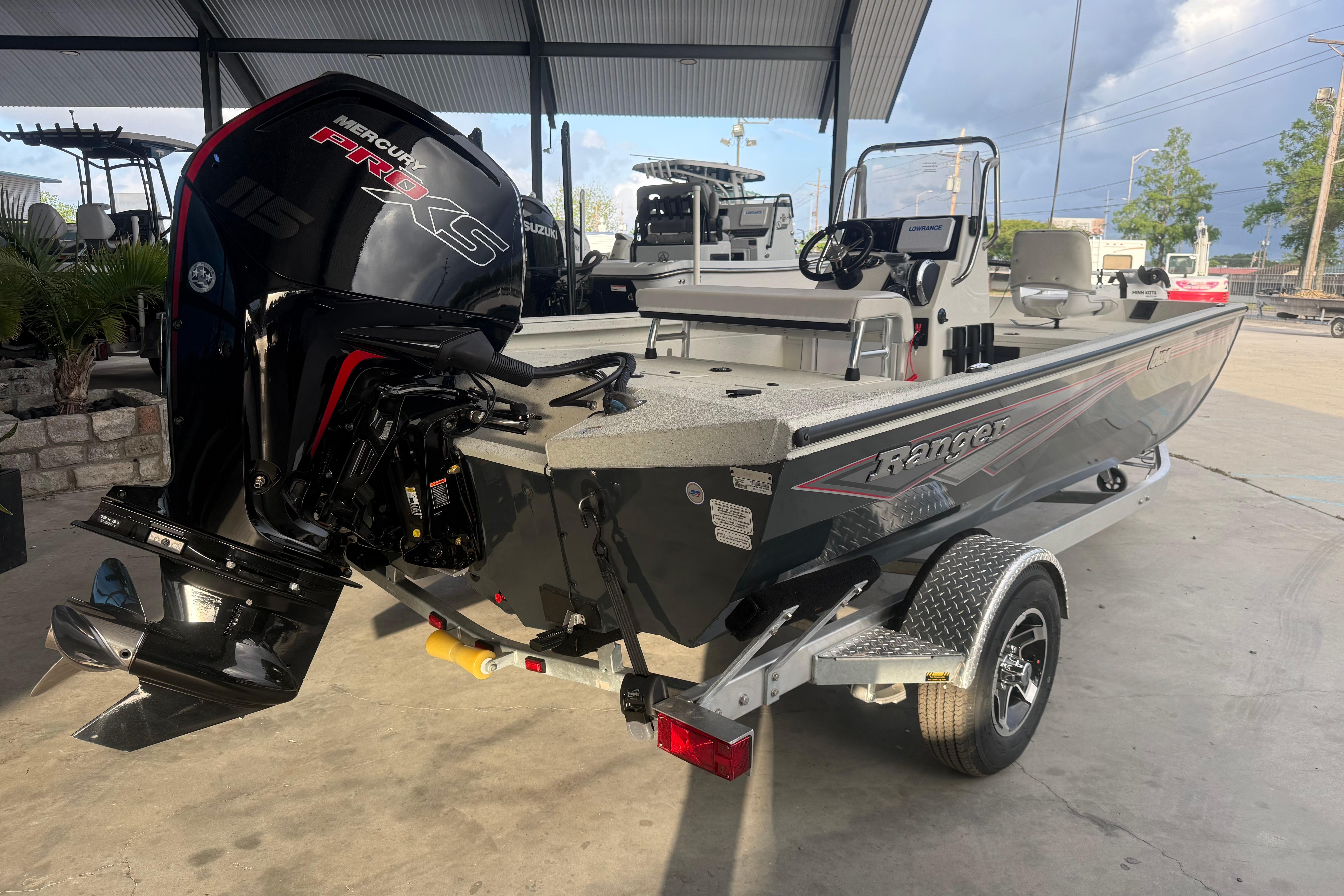 2026 Ranger RB190 boat with Mercury Pro XS engine on a trailer in a covered area.